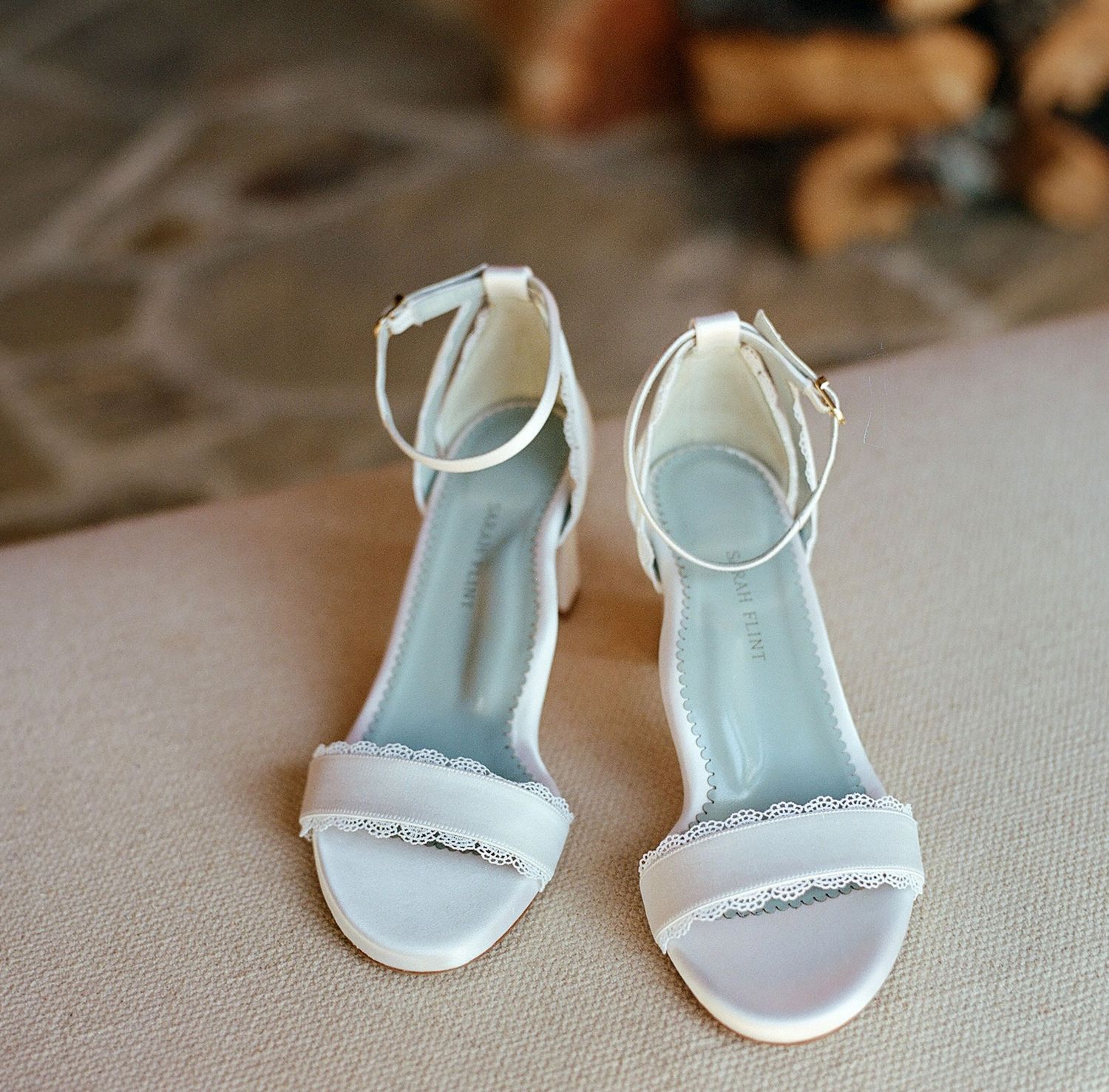 Elegant white bridal sandals with delicate ankle straps and subtle embellishments.