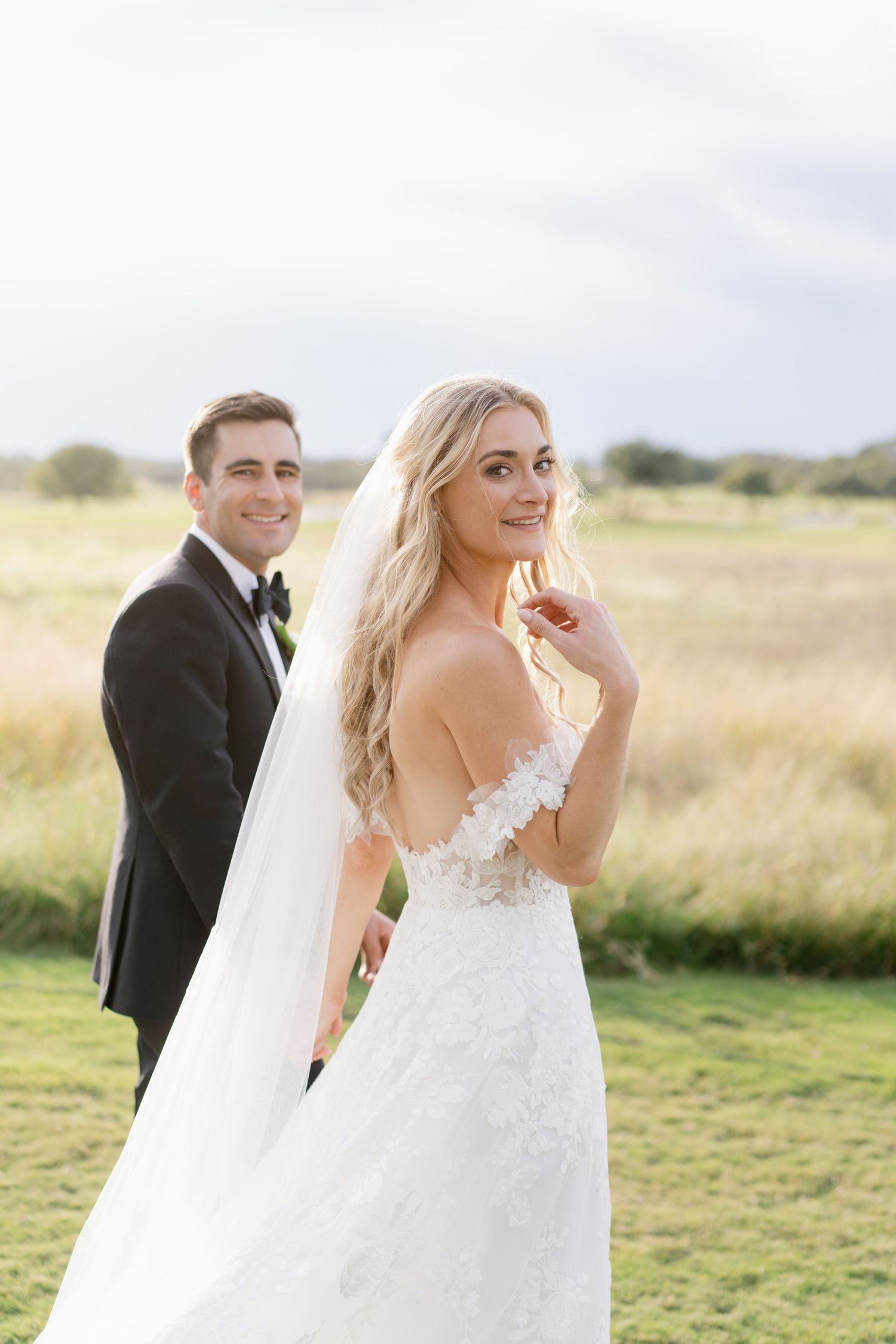 Romantic wedding photo session in a sun-lit meadow.