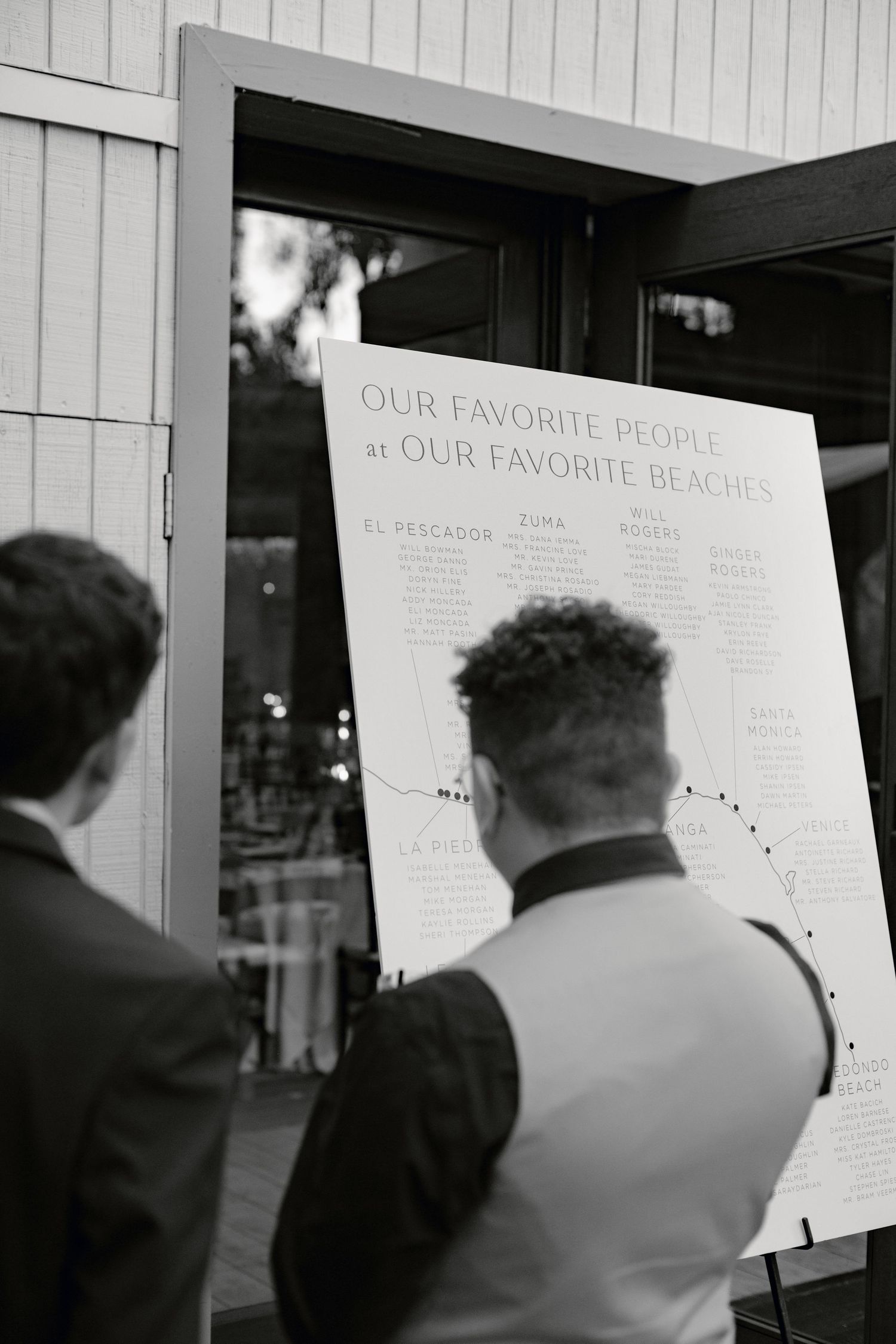 People viewing display boards with text at an event.