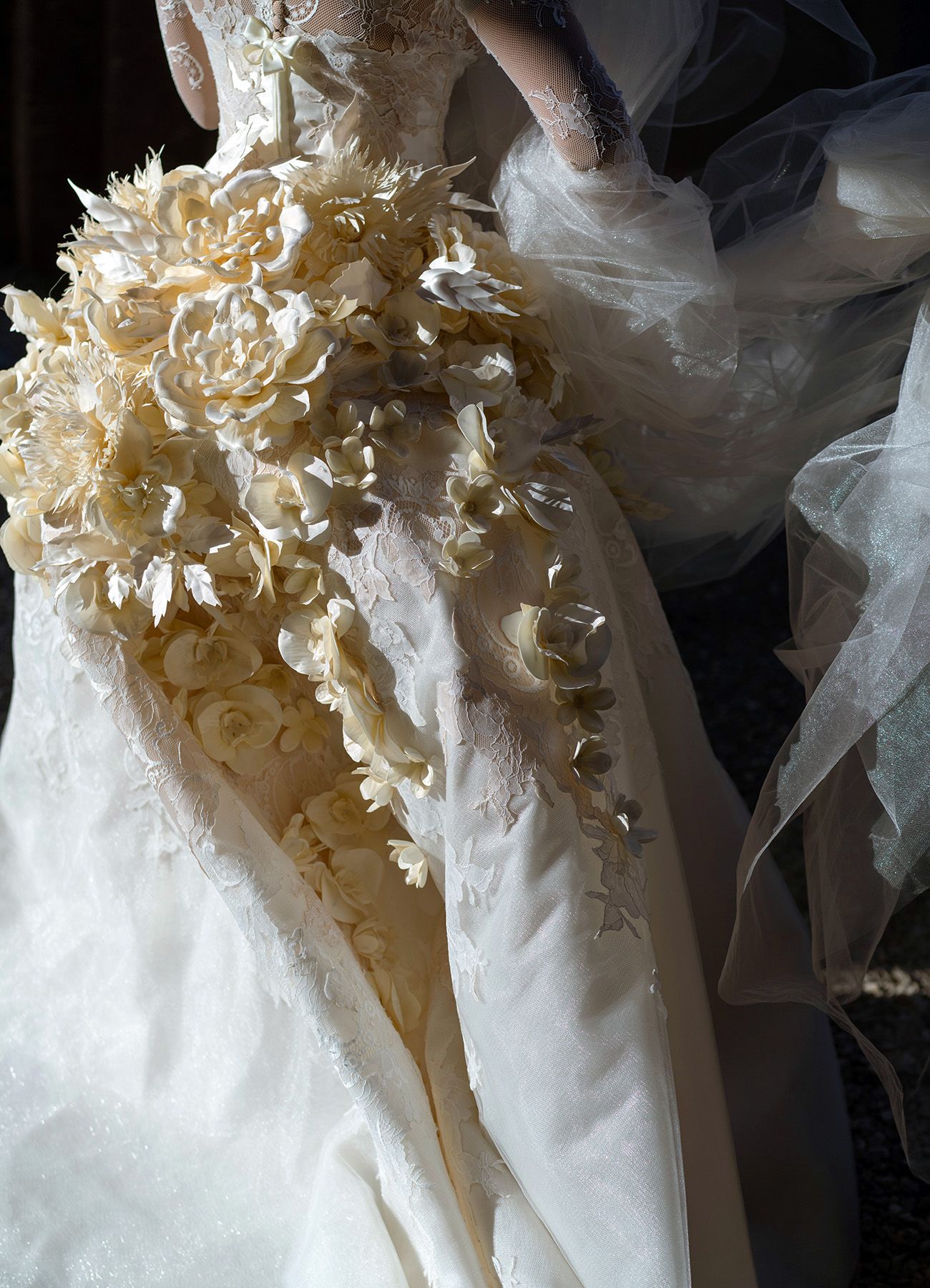 Delicate floral and tulle details on an ivory wedding dress.