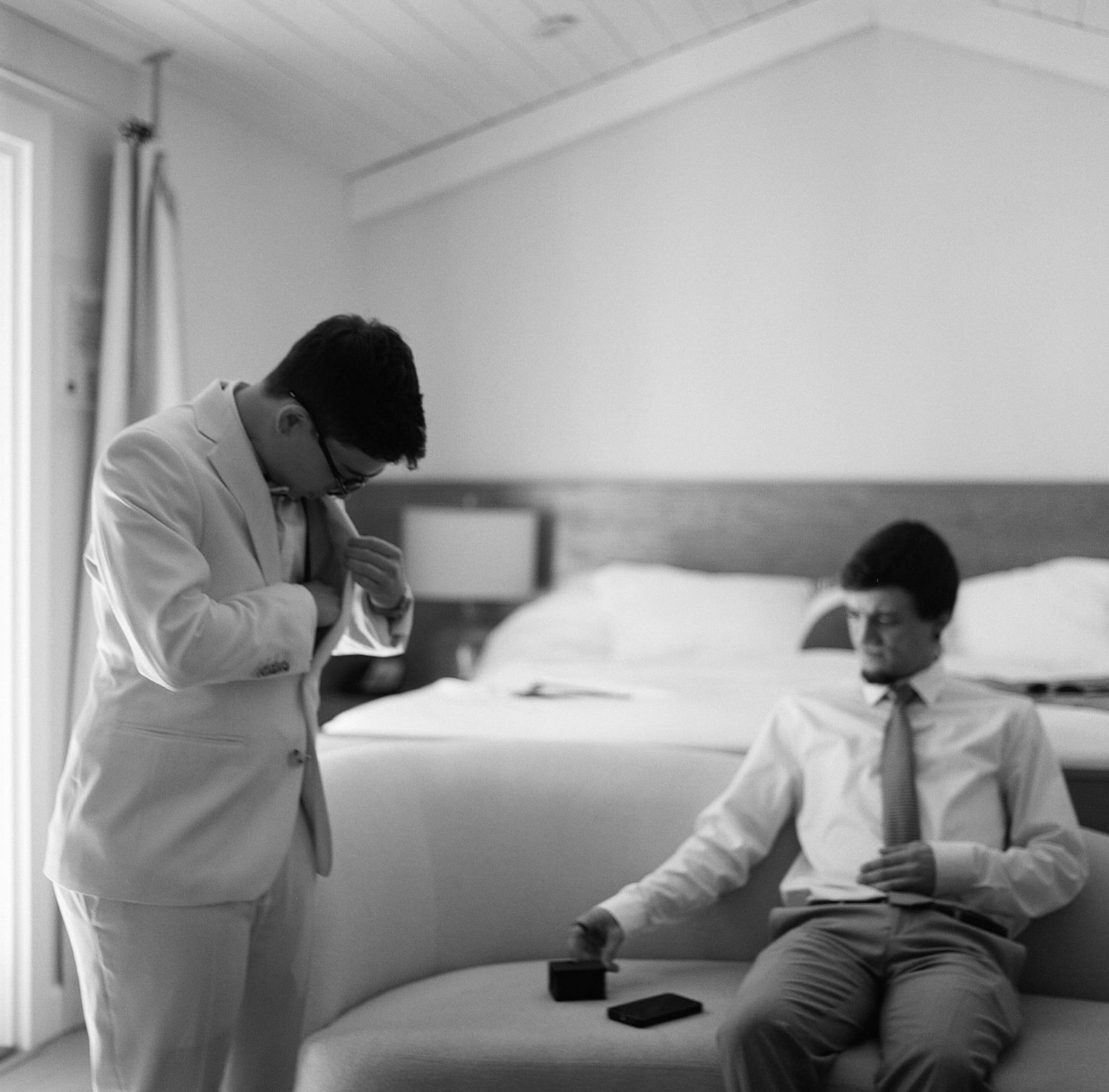 Black and white photos showing interaction in a bright interior space.
