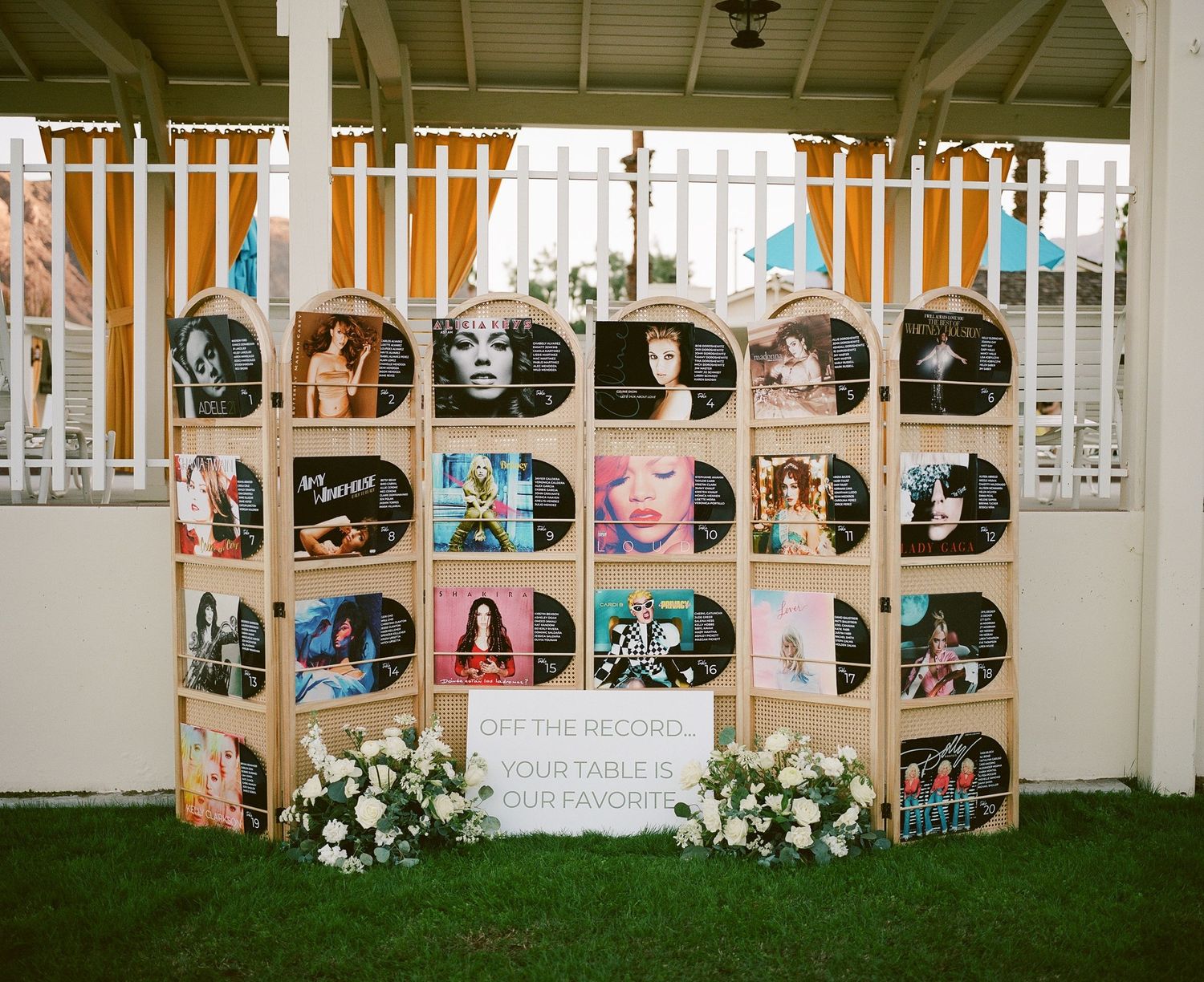 Wedding photo display wall with black and white portraits arranged in circular pattern.