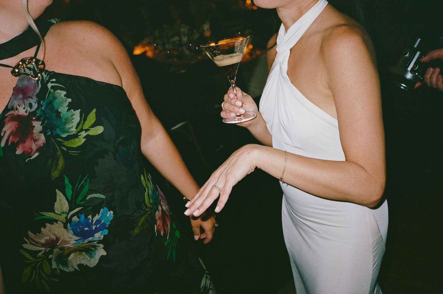 People dancing and celebrating at a party wearing formal attire.