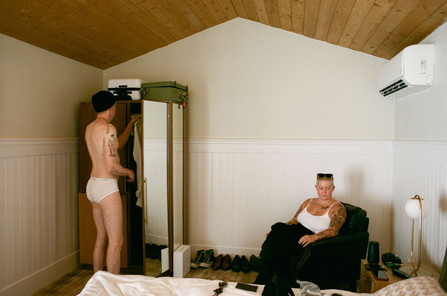 Interior room scene with wooden ceiling and white walls.