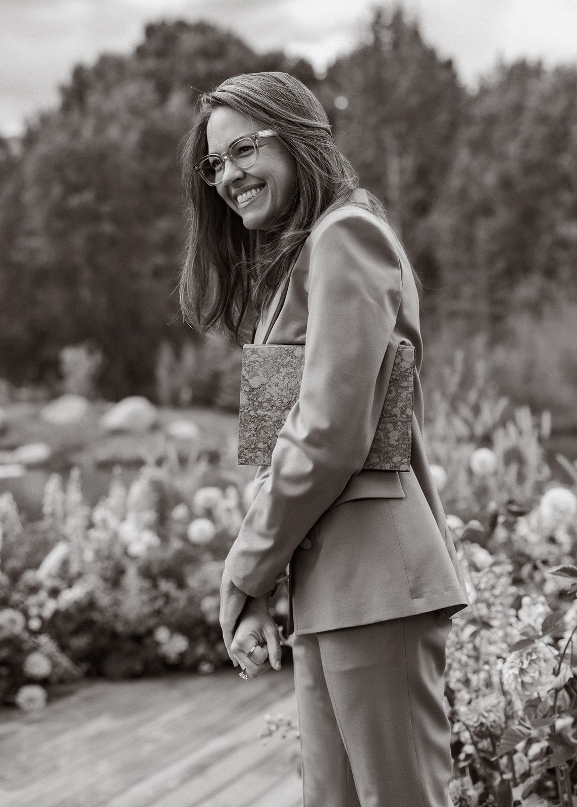 Black and white portrait series in a flower garden showing joyful moments.