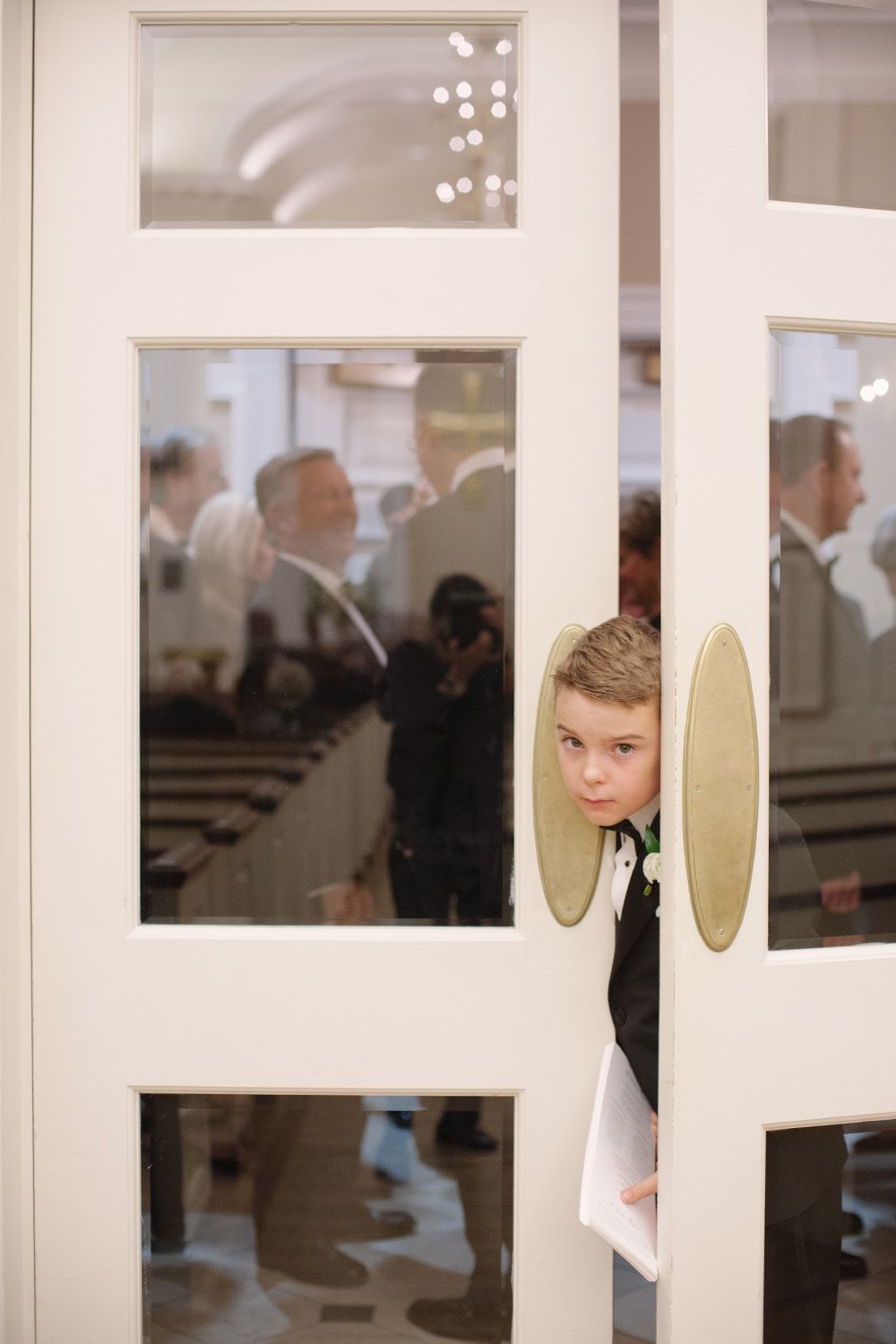 A glimpse through white French doors into an elegant indoor event space.