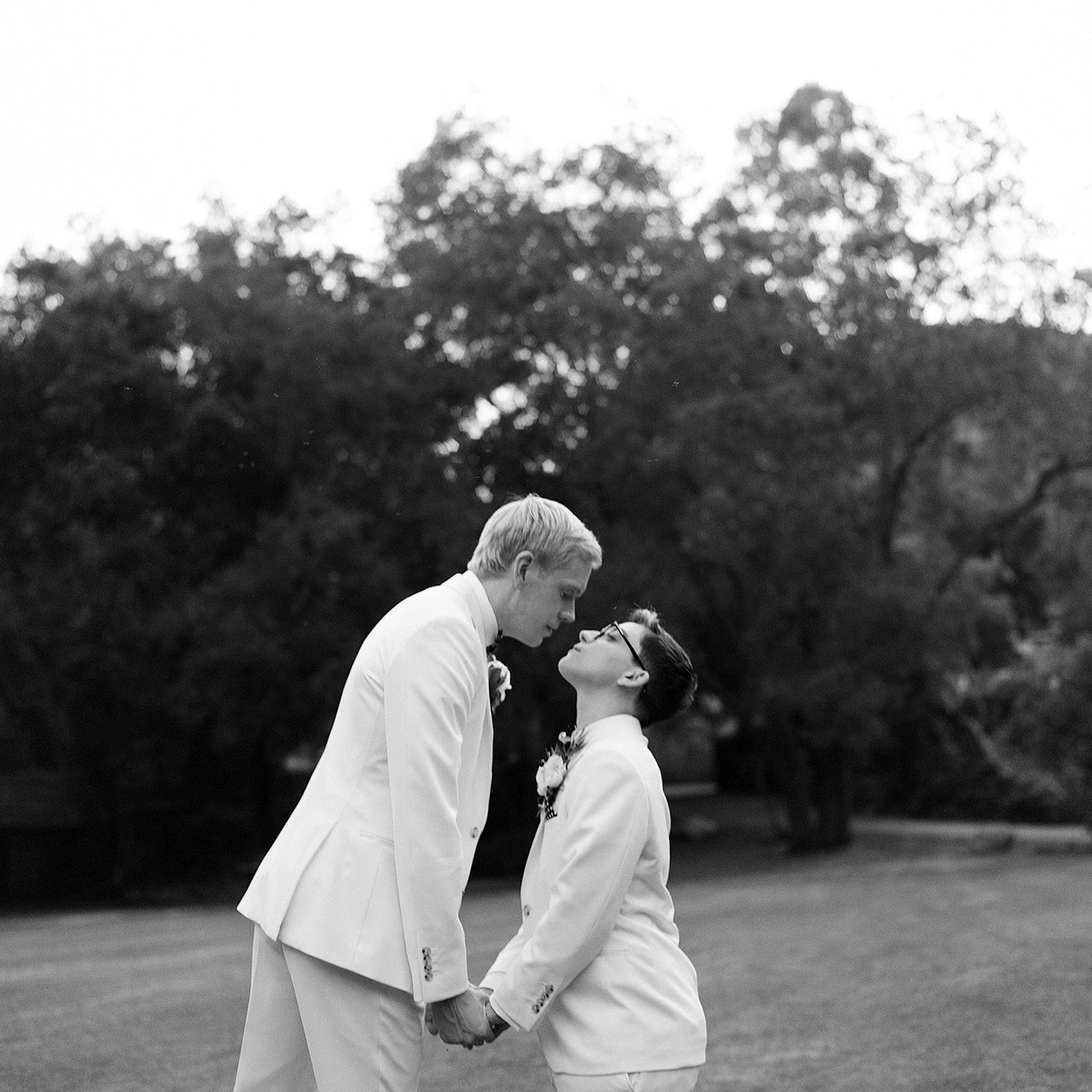 A romantic black and white sequence of a couple embracing in a park setting.