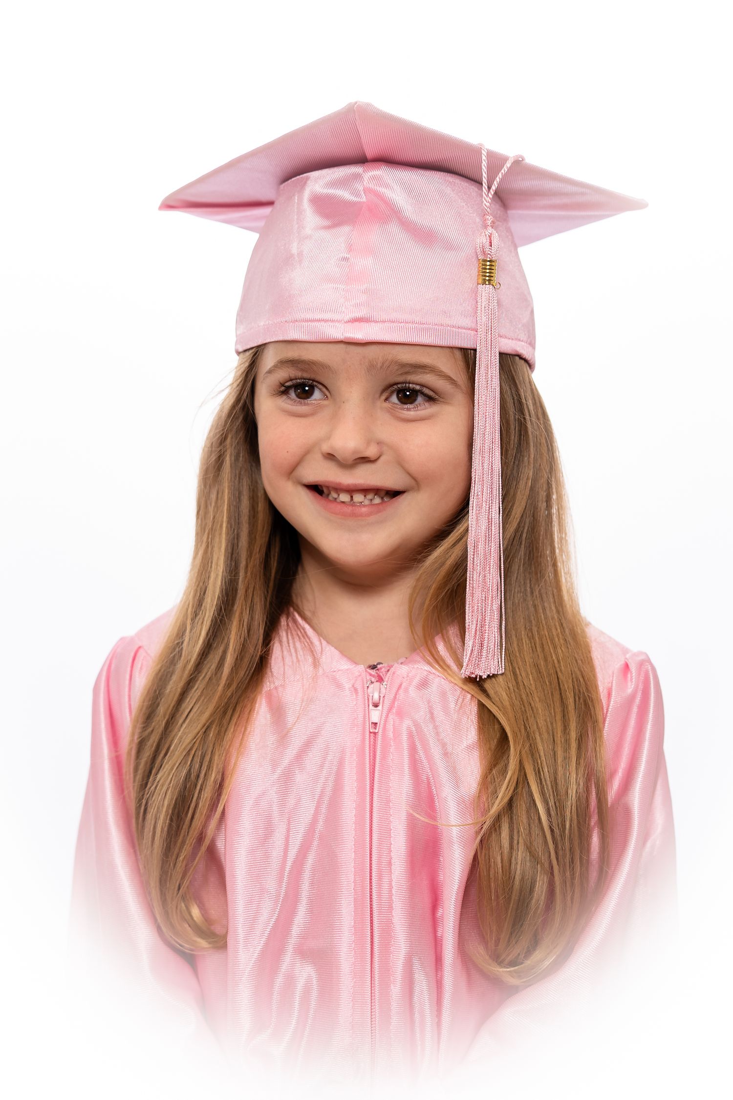 A graduate in a pink cap and gown with tassel smiles against a white background.