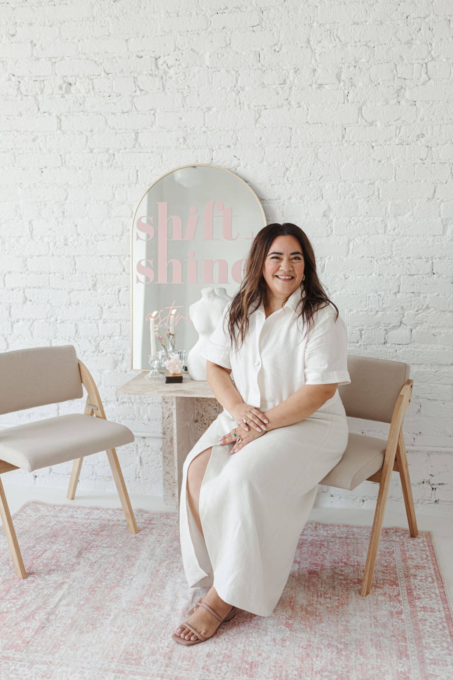 A series of photos showing someone in a white dress sitting on a beige chair against a white brick wall with a pink rug.