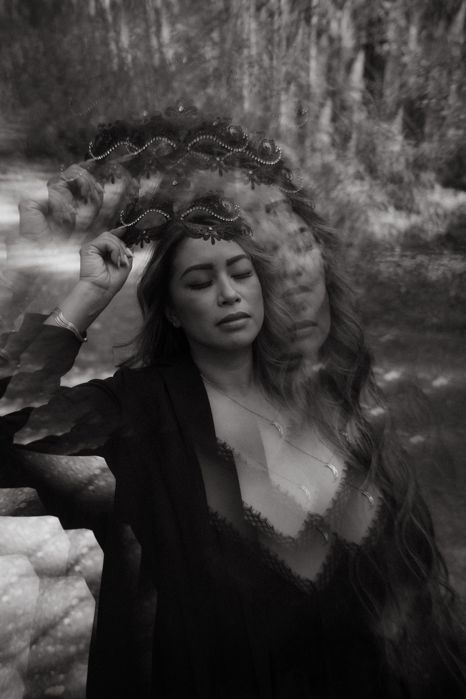 Moody black and white portrait series showing graceful movements with flowing dark fabric against a misty background.