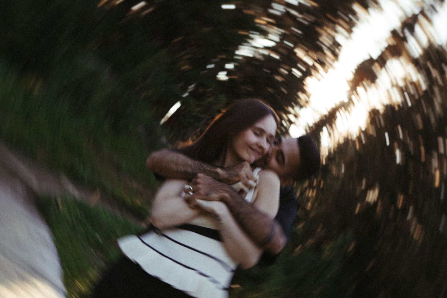 A sequence of blurred motion photographs showing a person lying in grass with sunlight filtering through trees.