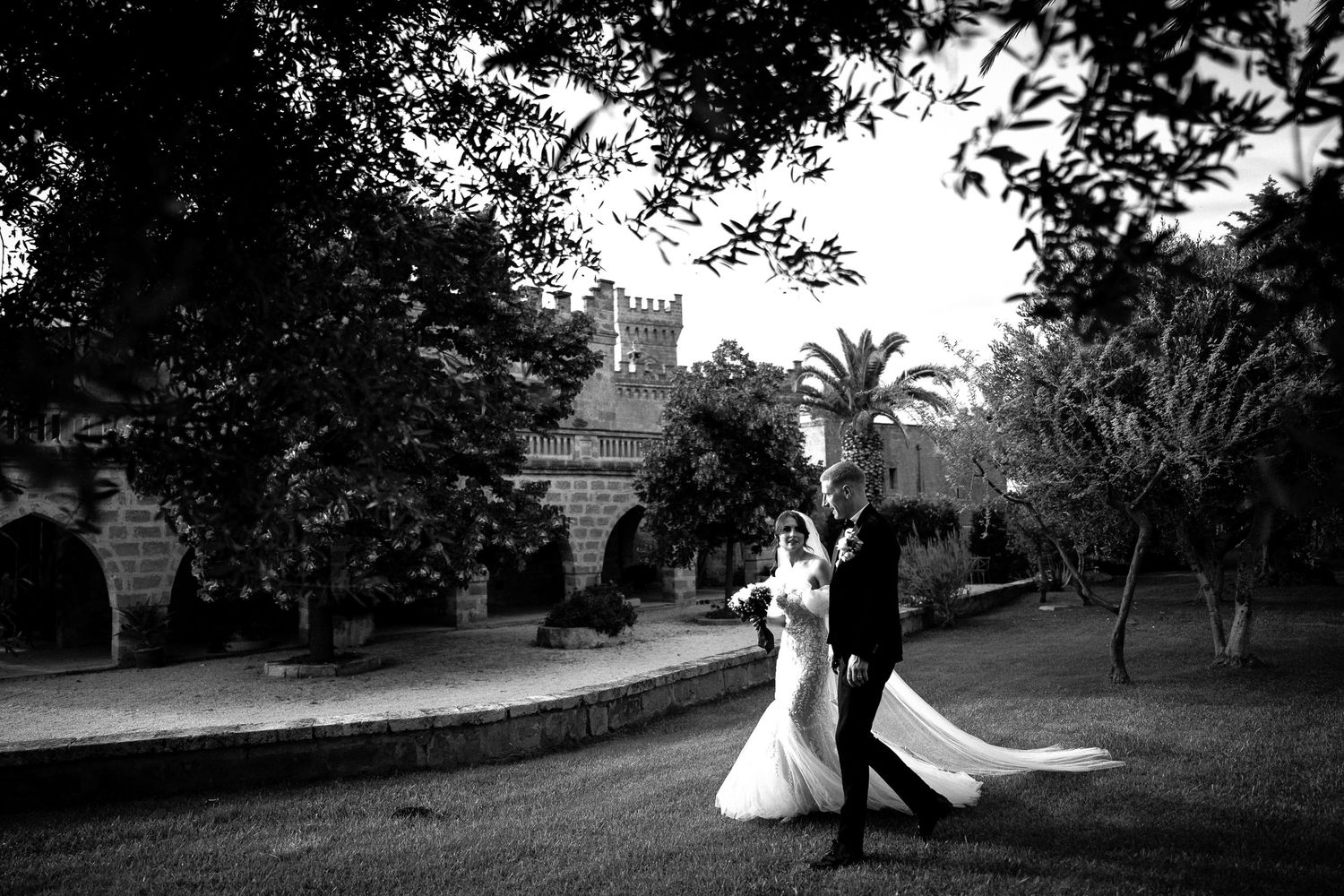 Black and white wedding photos displayed in a filmstrip style sequence showing romantic moments in an outdoor garden setting.