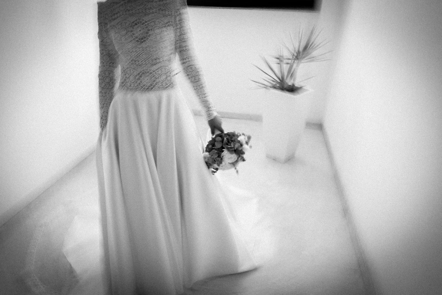 Black and white photo series showing a bride's wedding dress and veil in various artistic compositions and angles.