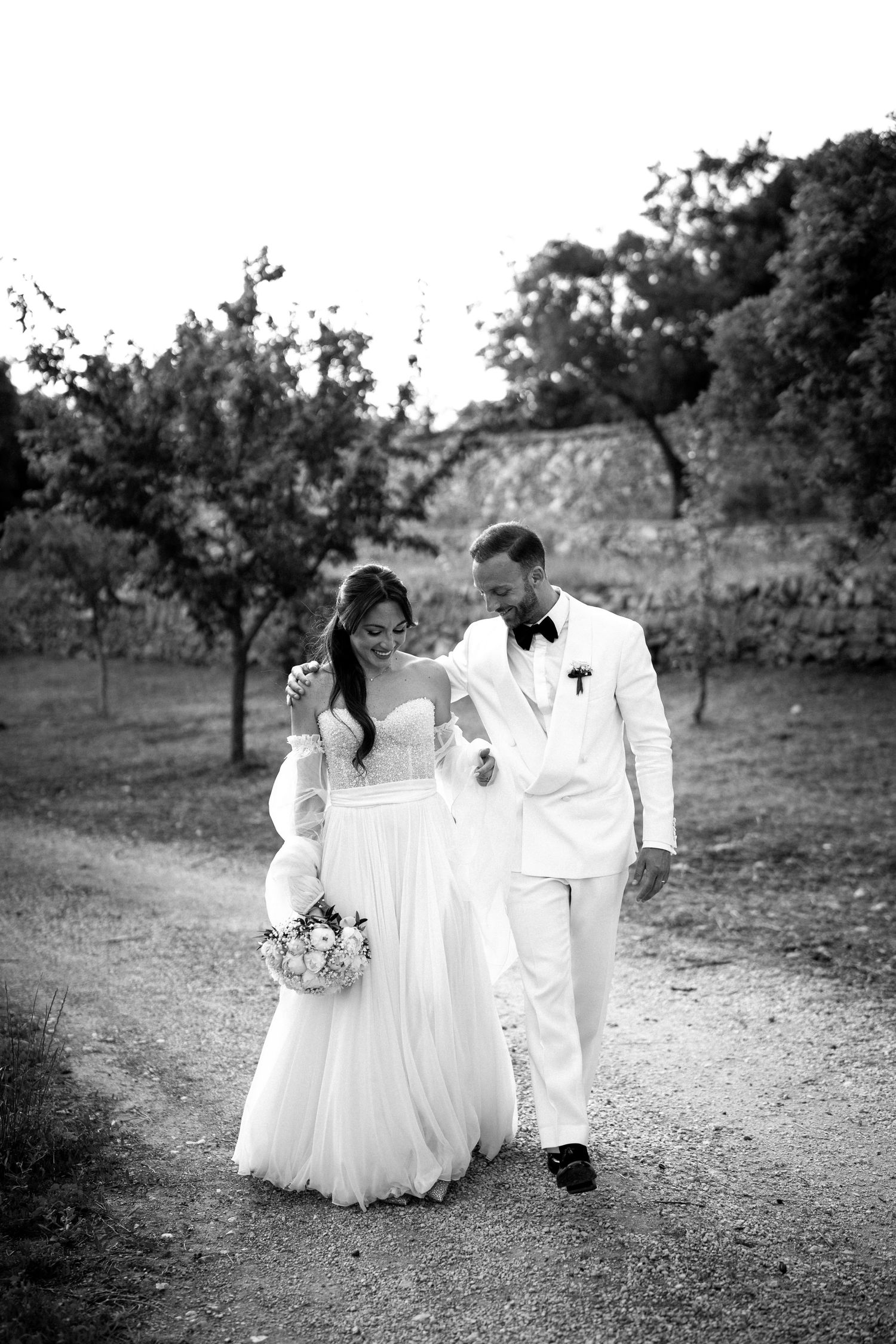 Black and white romantic wedding sequence showing couple dancing together in an orchard setting.