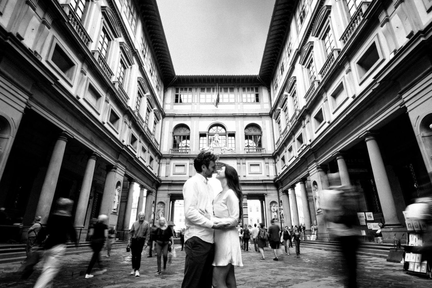 A series of black and white architectural photographs showing urban walkways and corridors with dramatic perspective.