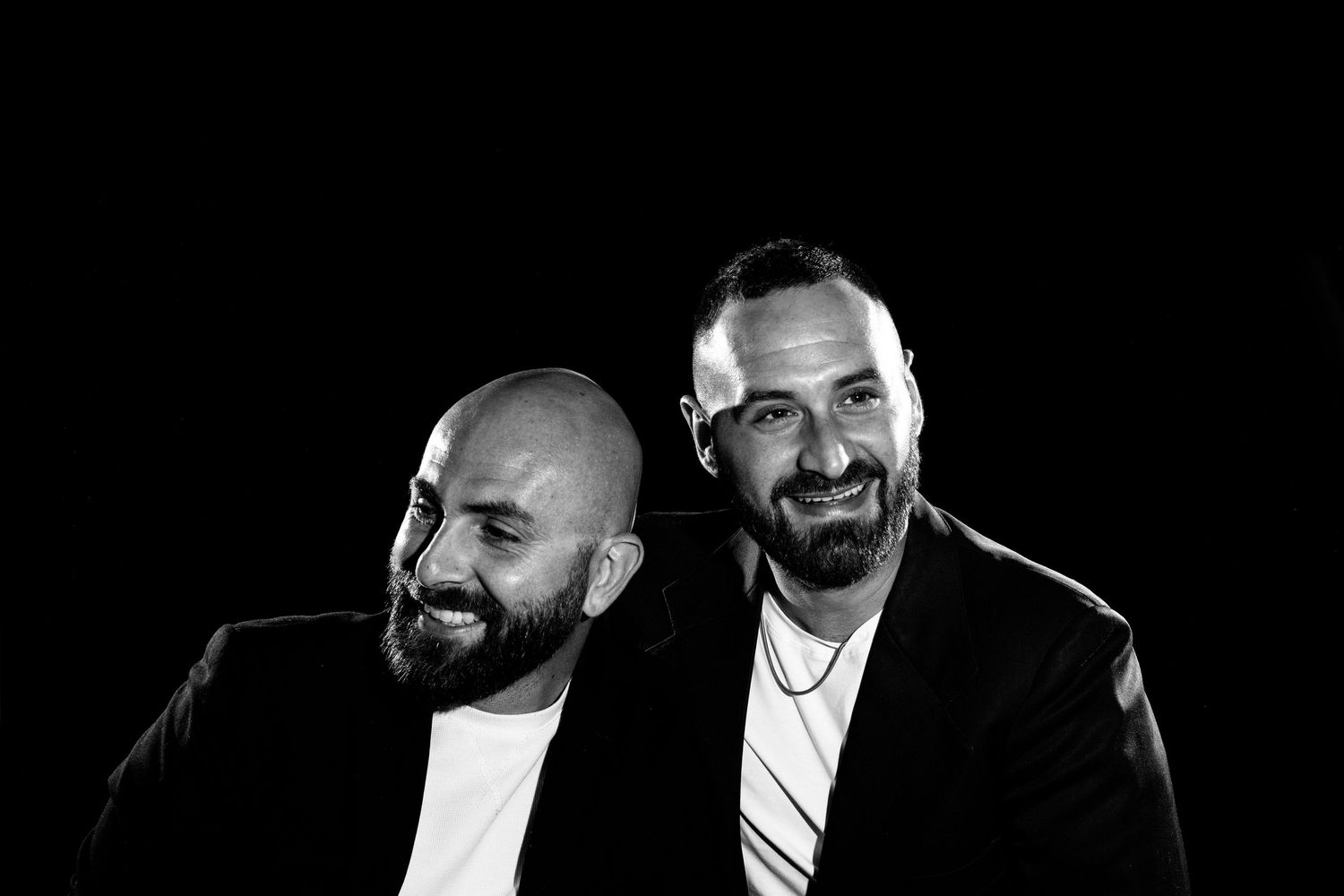A series of black and white headshots showing a bearded man in different poses against a dark background.
