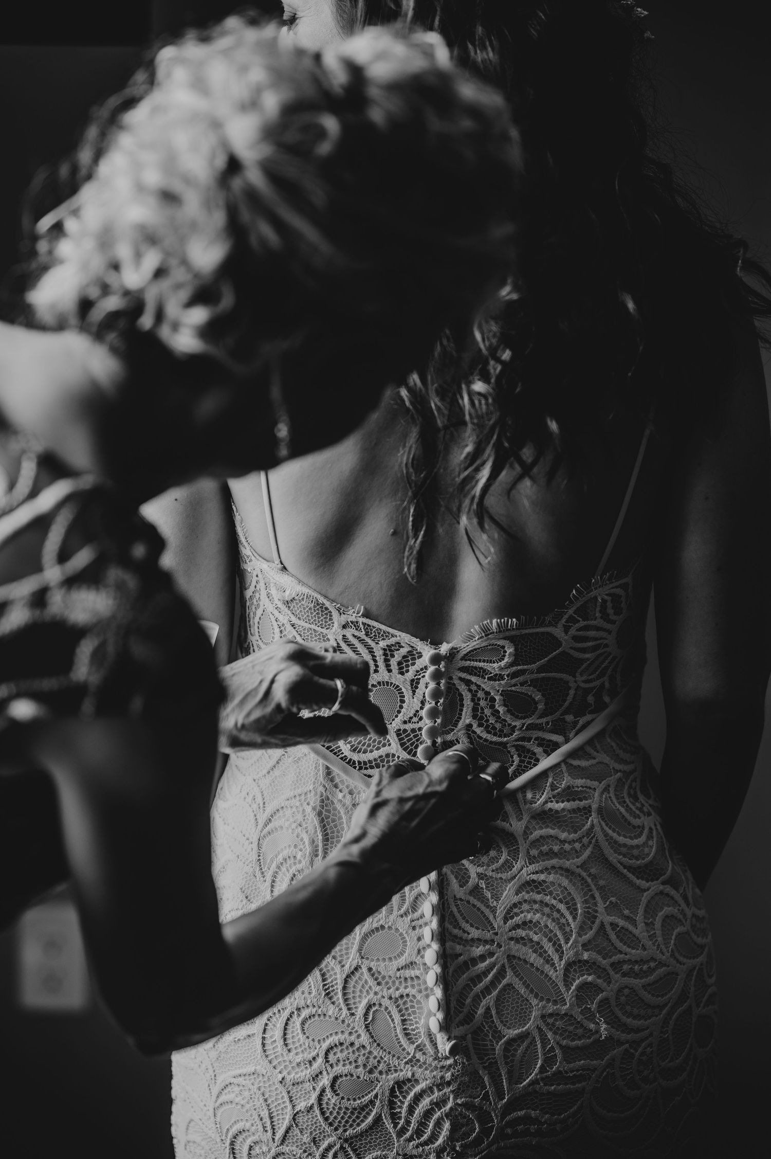 Intimate black and white detail shots of intricate lace wedding dress patterns.