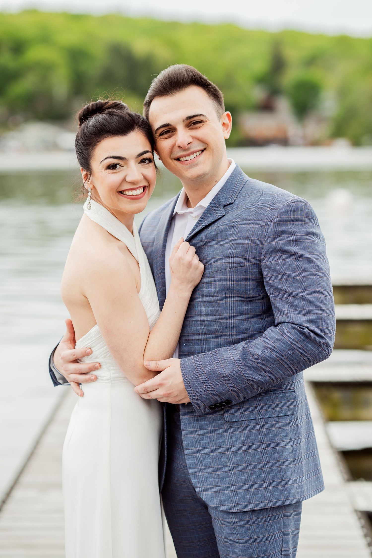 A romantic waterfront wedding photo session with a couple in formal attire.