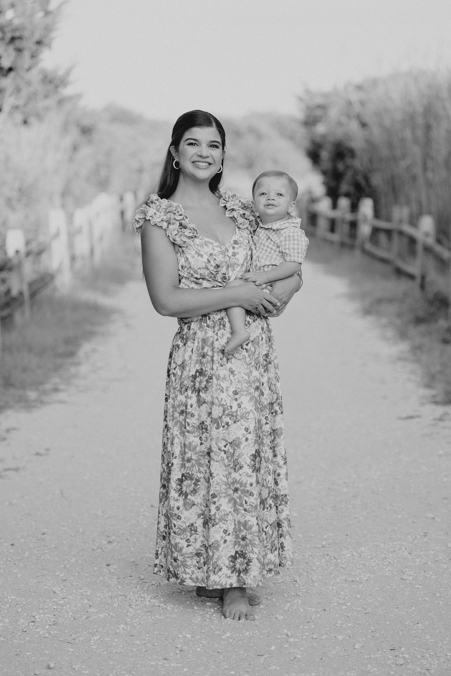 Black and white portraits on tree-lined pathway in park setting.