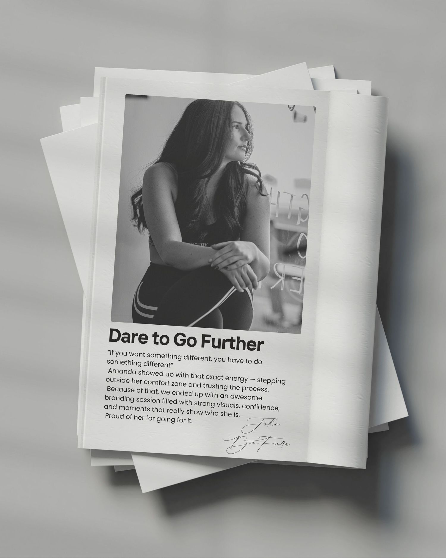 A series of minimalist book or magazine pages shown in a fanned out arrangement with text and monochrome design elements.