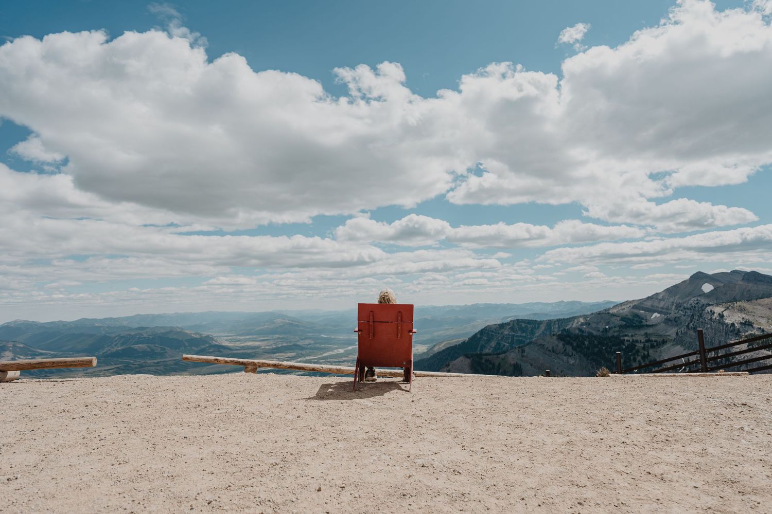 A panoramic mountain landscape view with dramatic cloudy skies and distant peaks stretches across multiple frames.