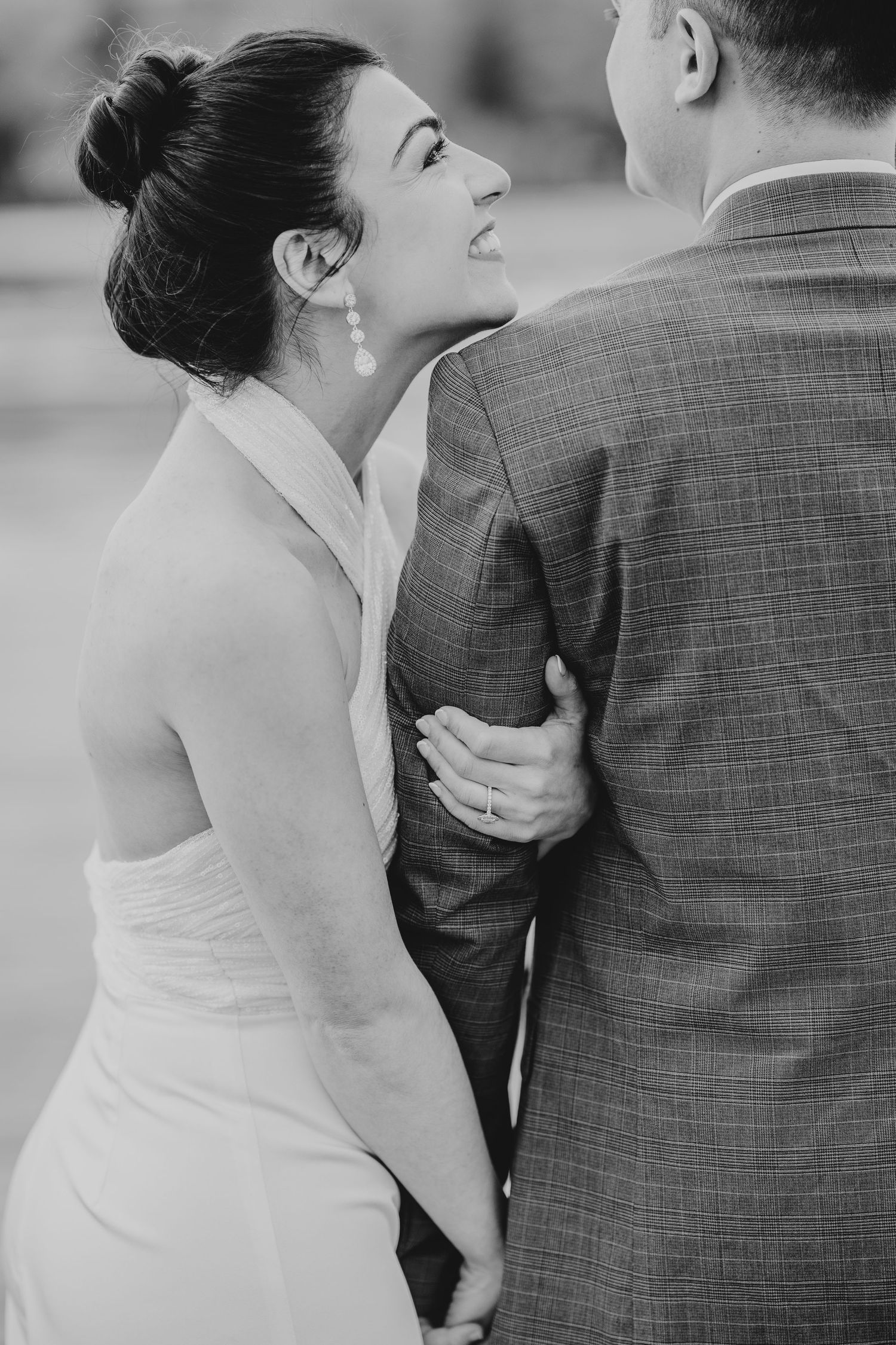 A close-up shot of a couple embracing in formal attire during an intimate moment.