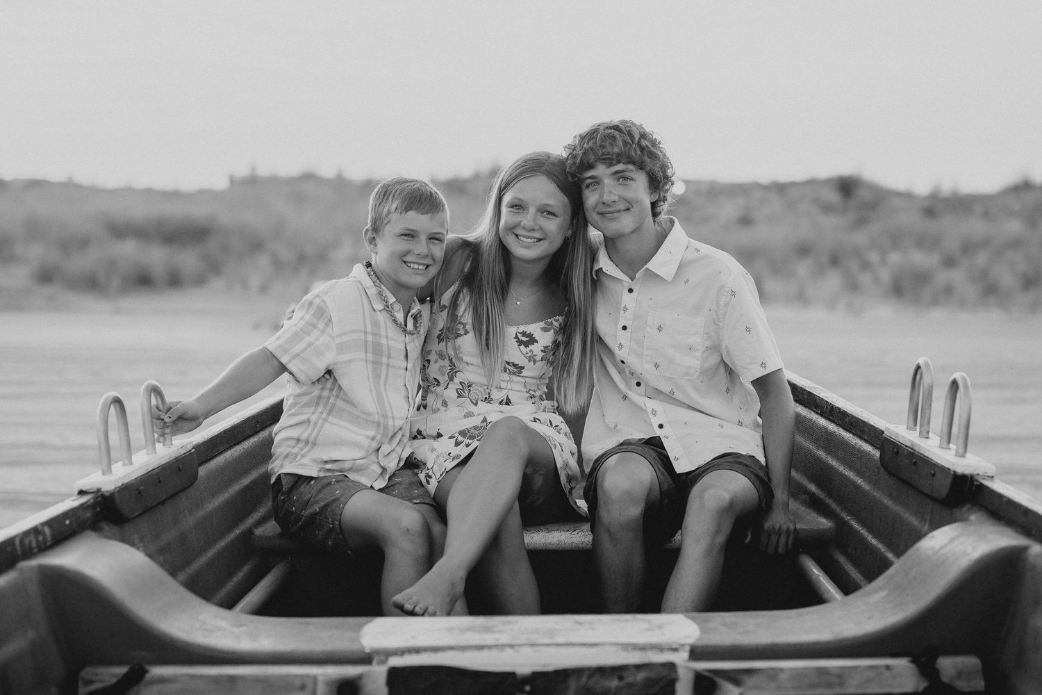 family children enjoying relaxed moment in vintage wooden boat.