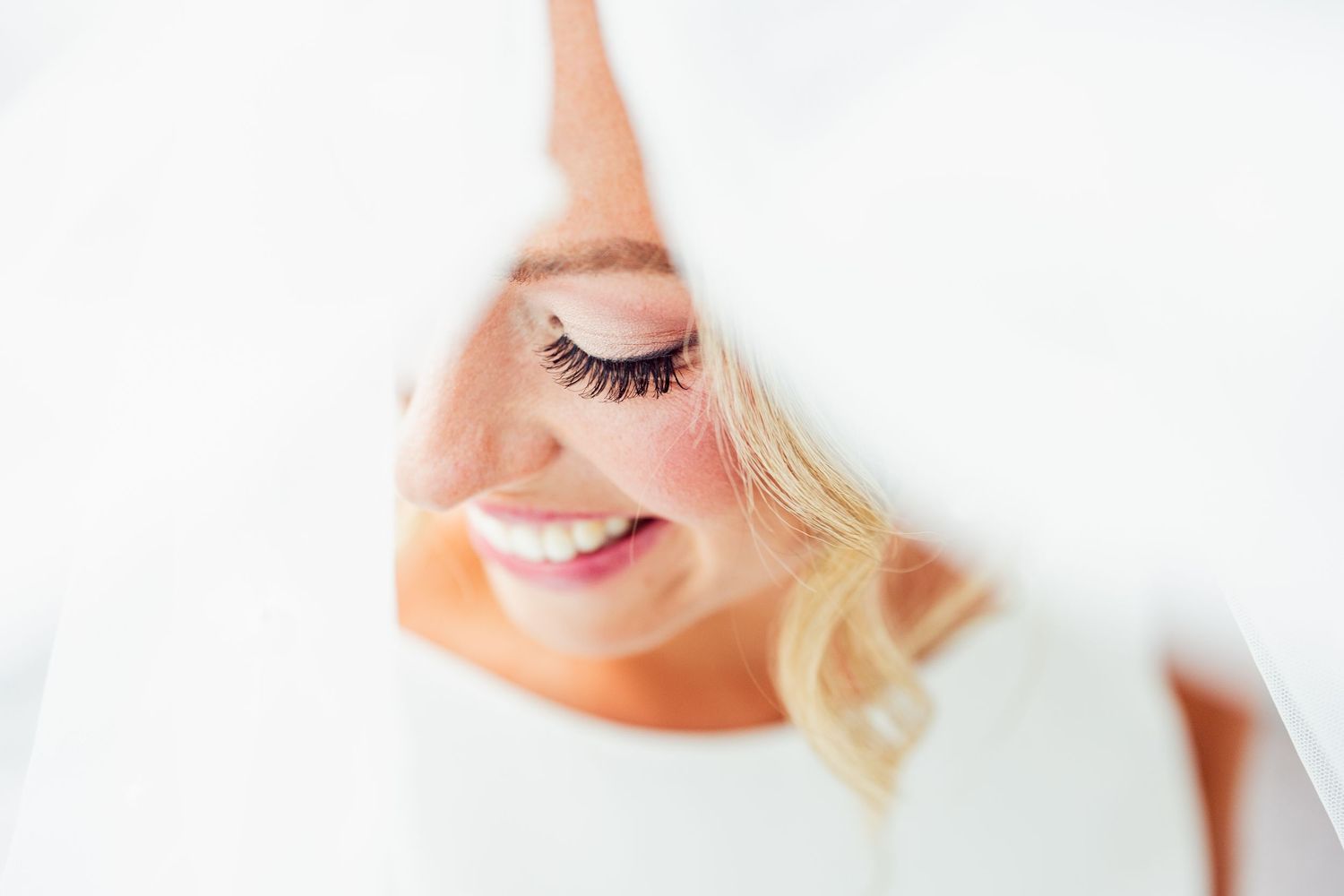 Soft portrait details in high key lighting against white background.