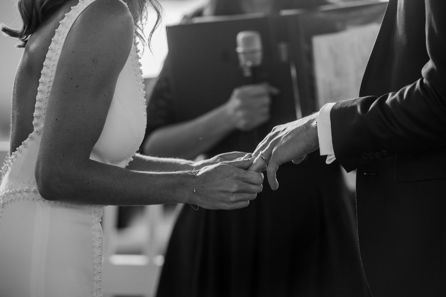 Black and white photo capturing elegant formal attire and champagne glasses.