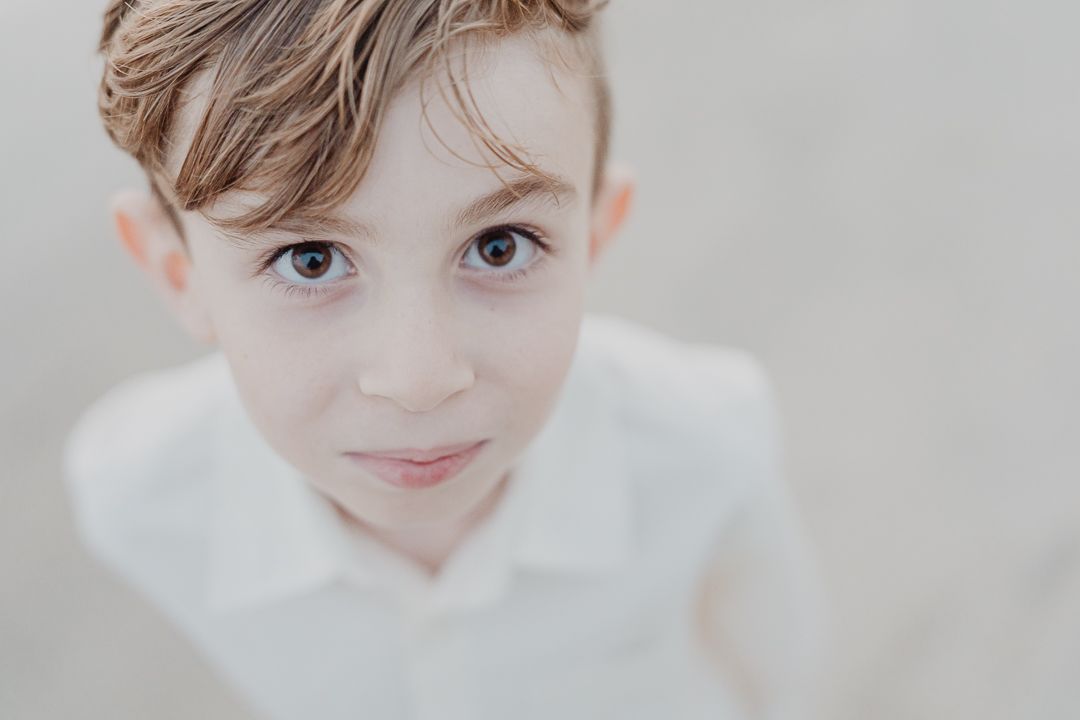 Close-up portraits showing bright eyes and gentle expressions in soft lighting.