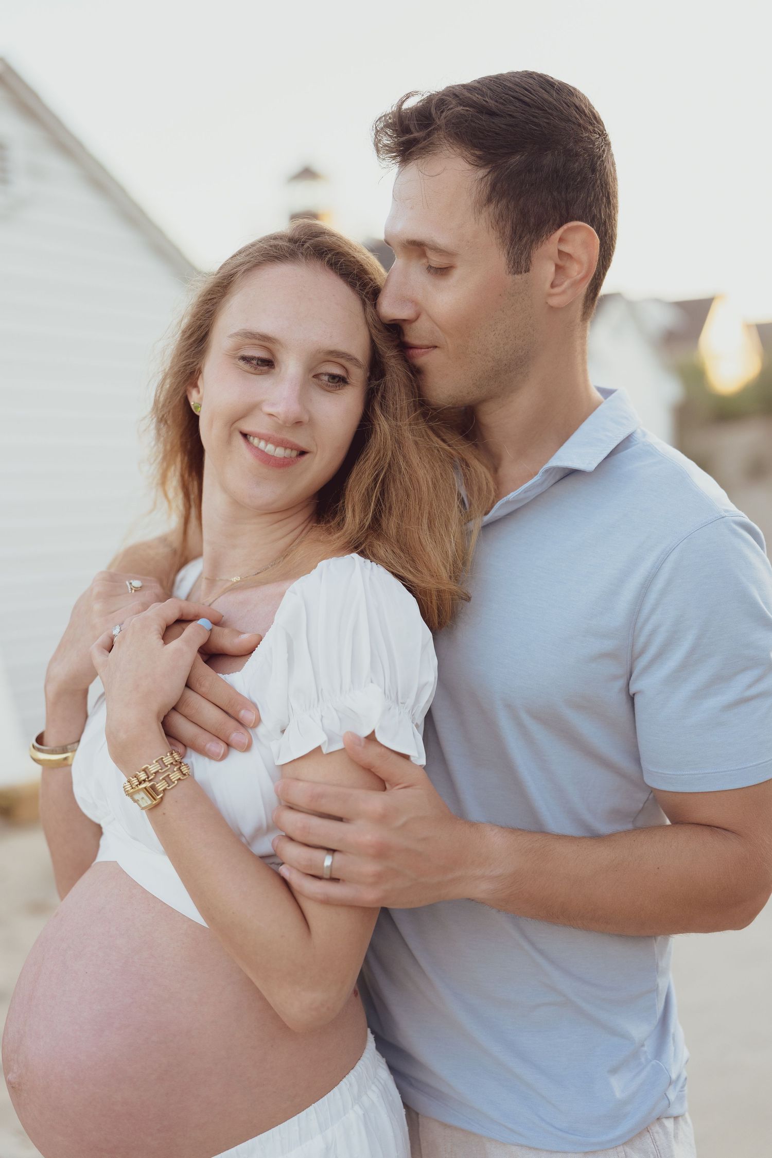 Intimate beach photoshoot capturing tender moments between a couple.