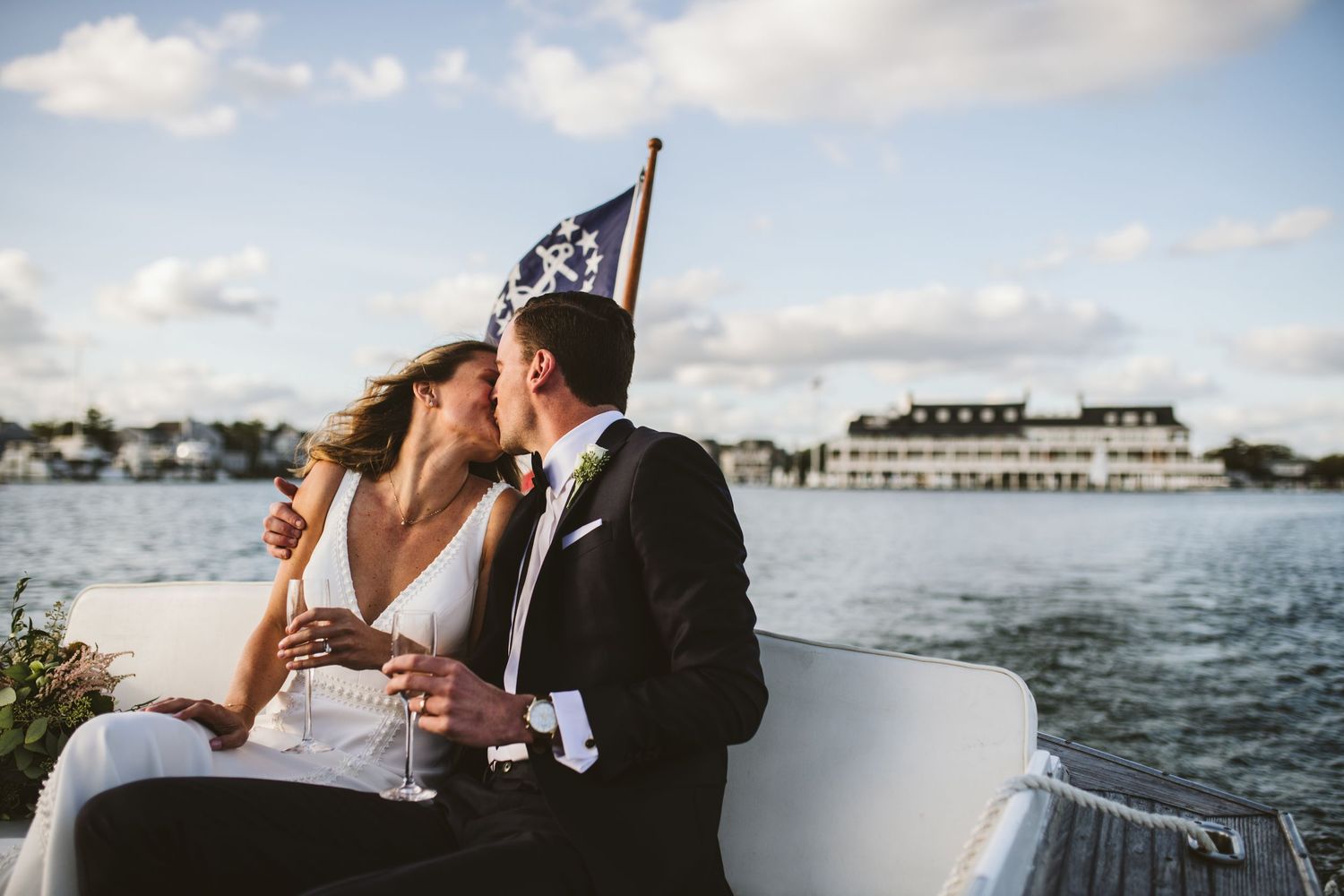 Seaside celebration with boats and harbor views under cloudy summer skies.