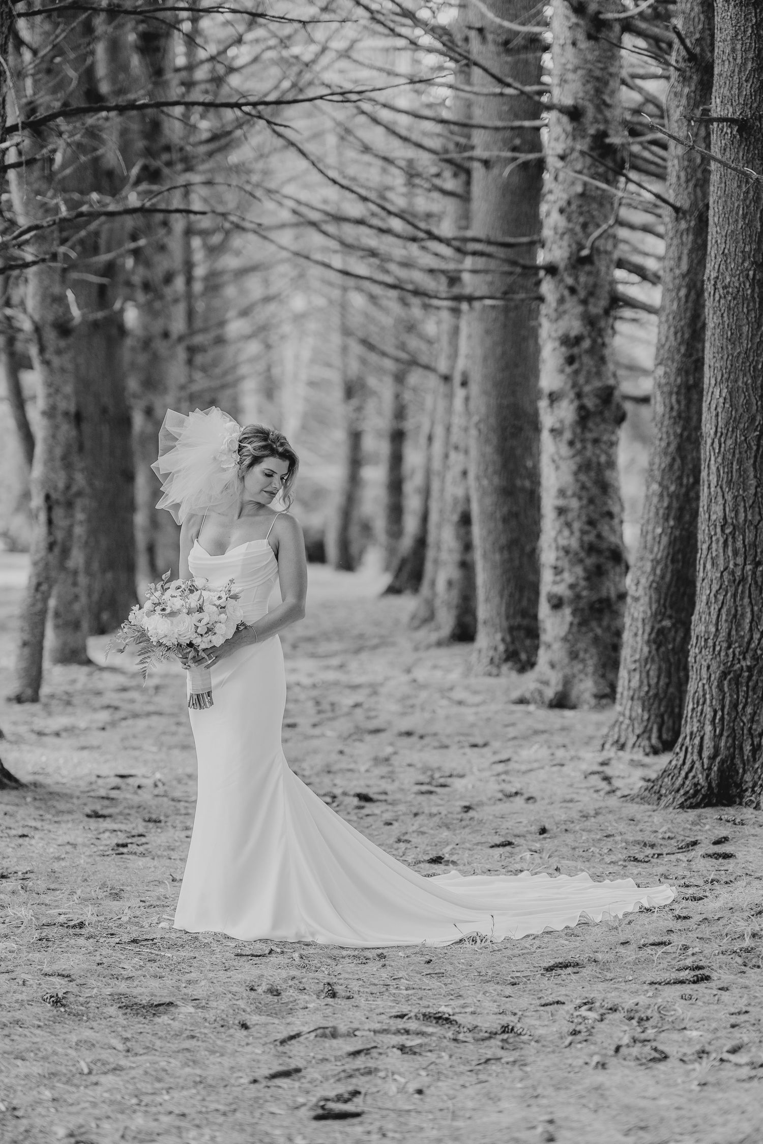 Black and white wedding portraits captured in a dramatic forest setting.
