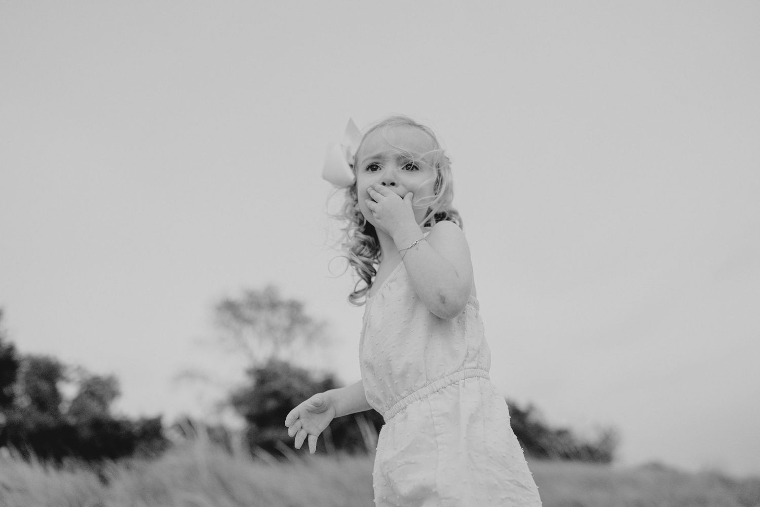 Black and white portraits showing gentle expressions against a neutral background.