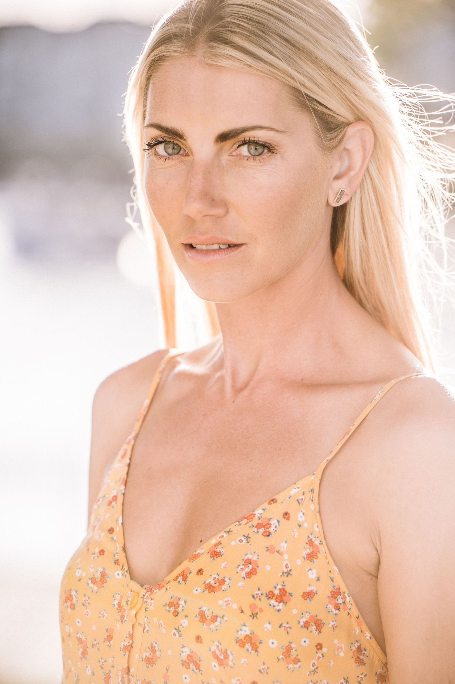 A series of portraits showing someone in a peach-colored floral sundress against a bright, soft-focus background.
