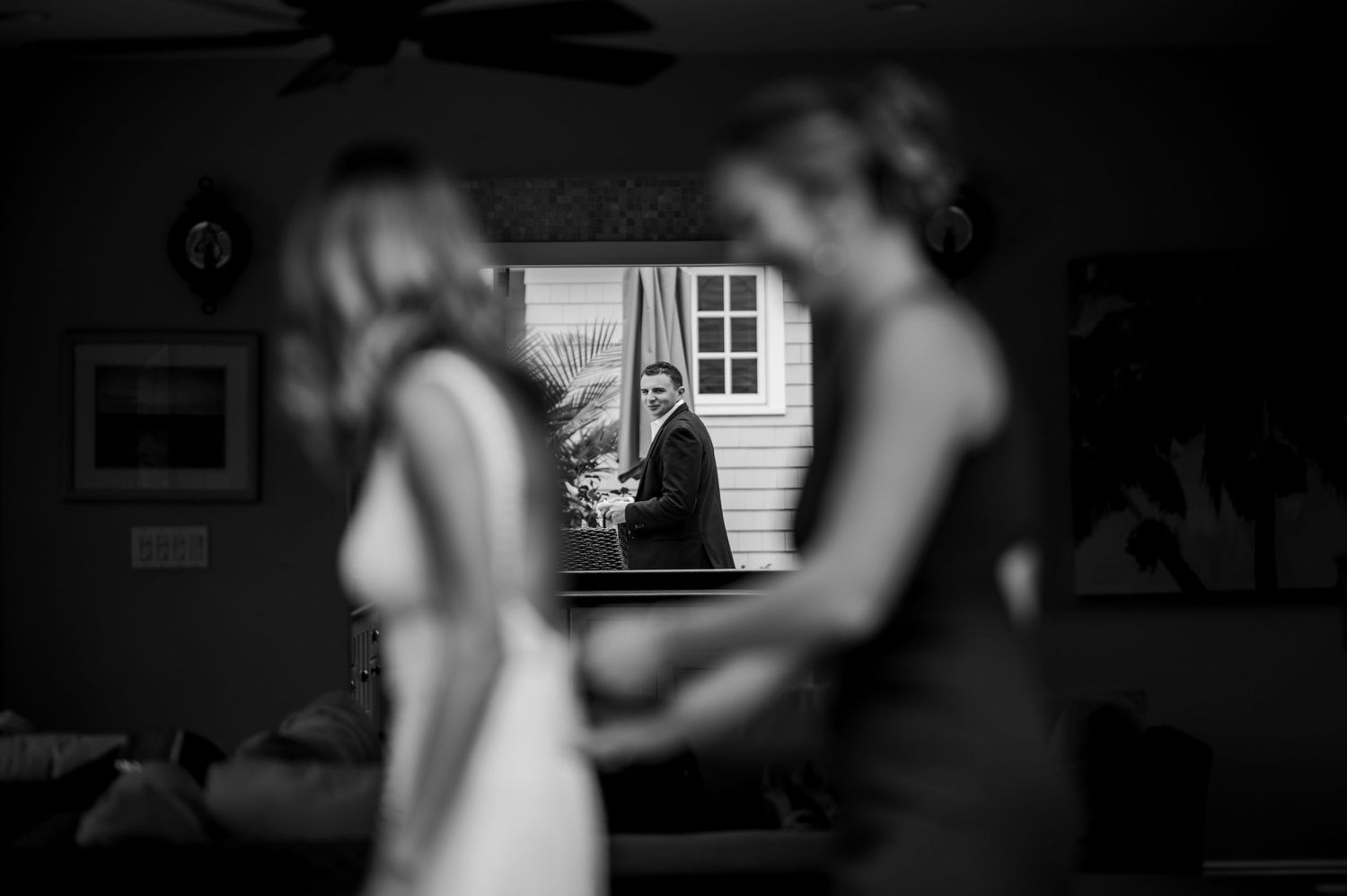 Dark interior silhouette shot with window light creating dramatic shadows.