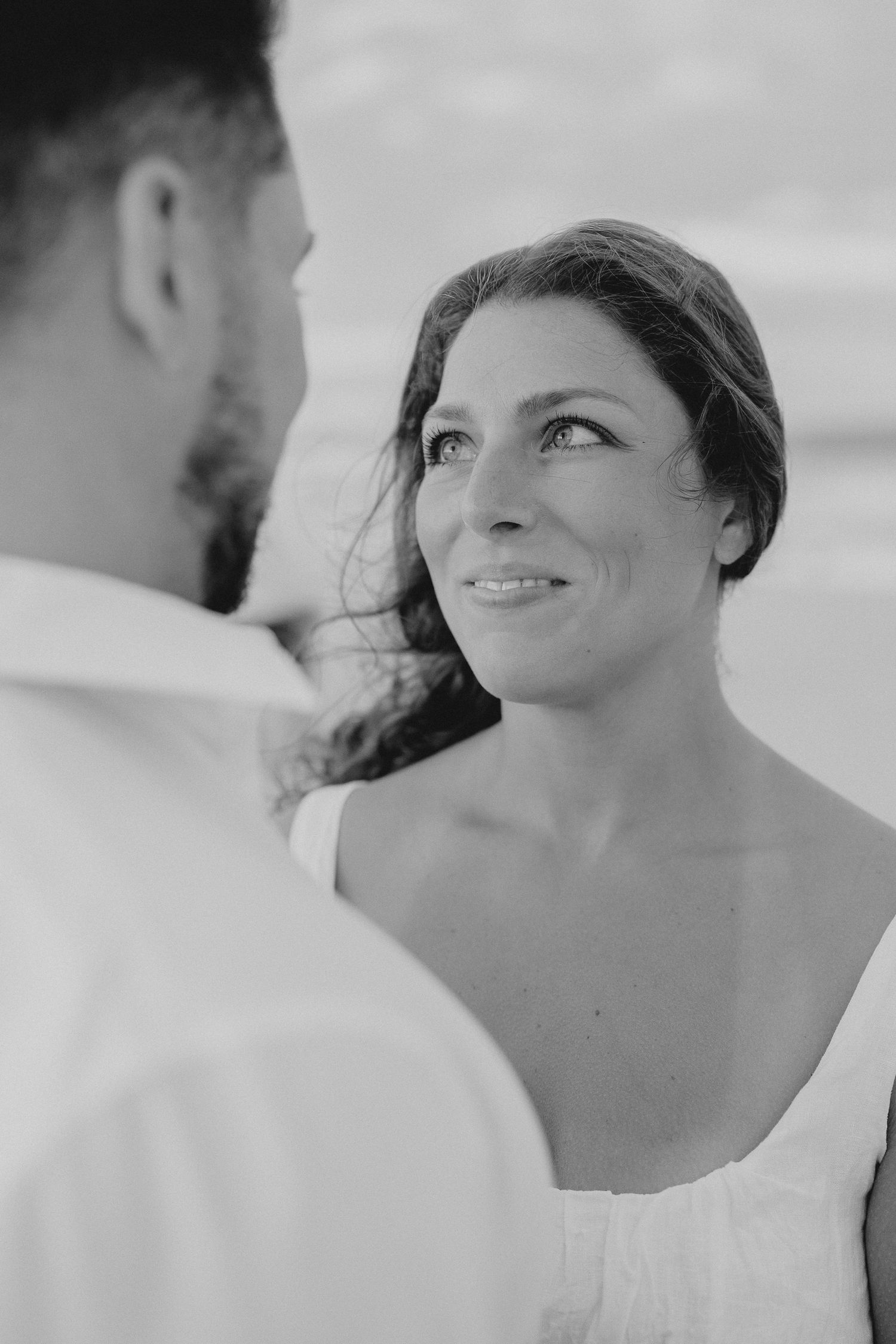 Black and white close-up portraits showing joyful expressions and genuine emotion.