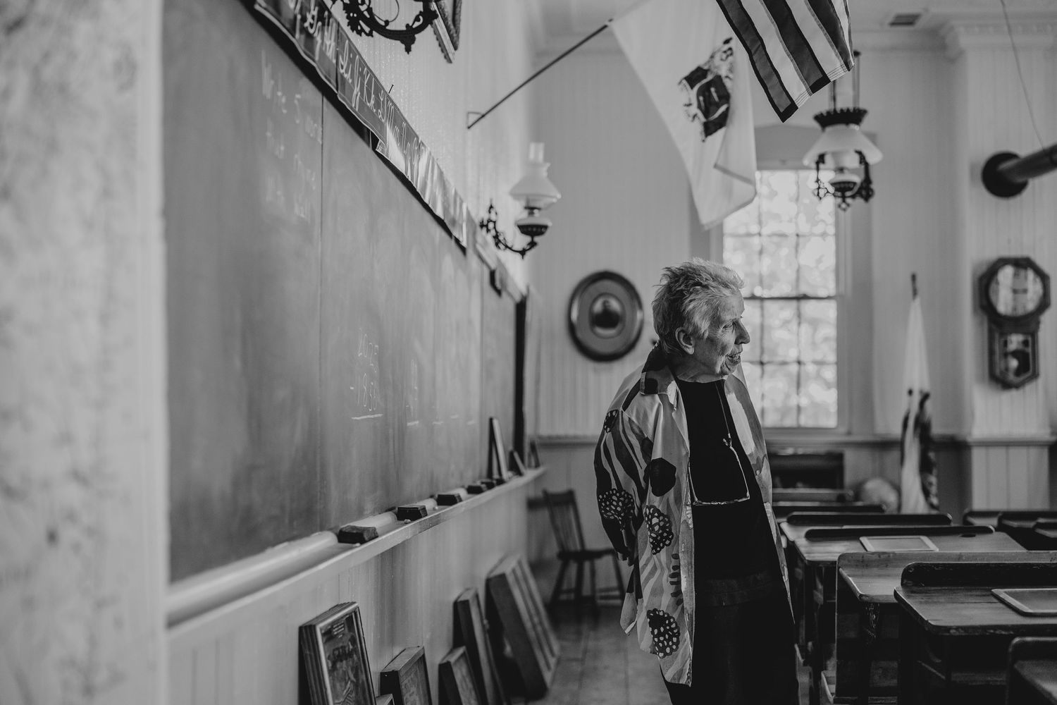 A black and white photo montage showing different interior views of a vintage industrial or institutional space.