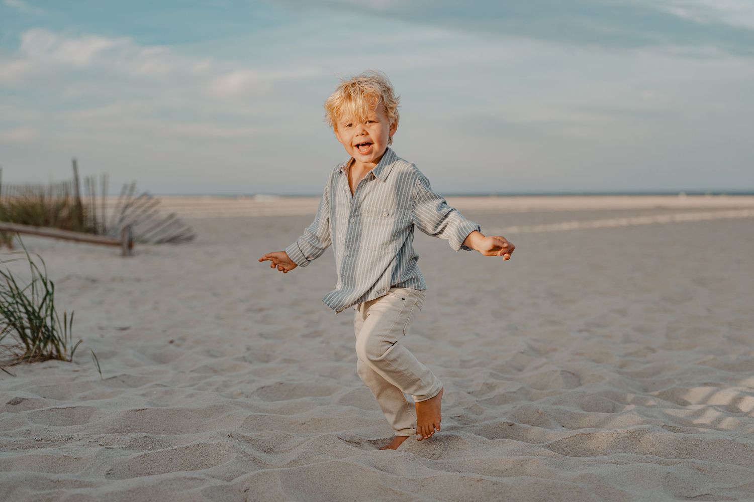 Joyful playtime at the beach with sand and ocean waves in the background.