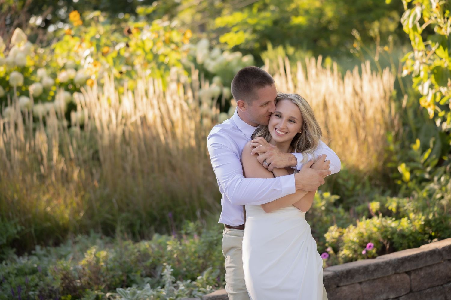 Romantic couple portraits in a garden setting with tall golden grasses and autumn foliage.
