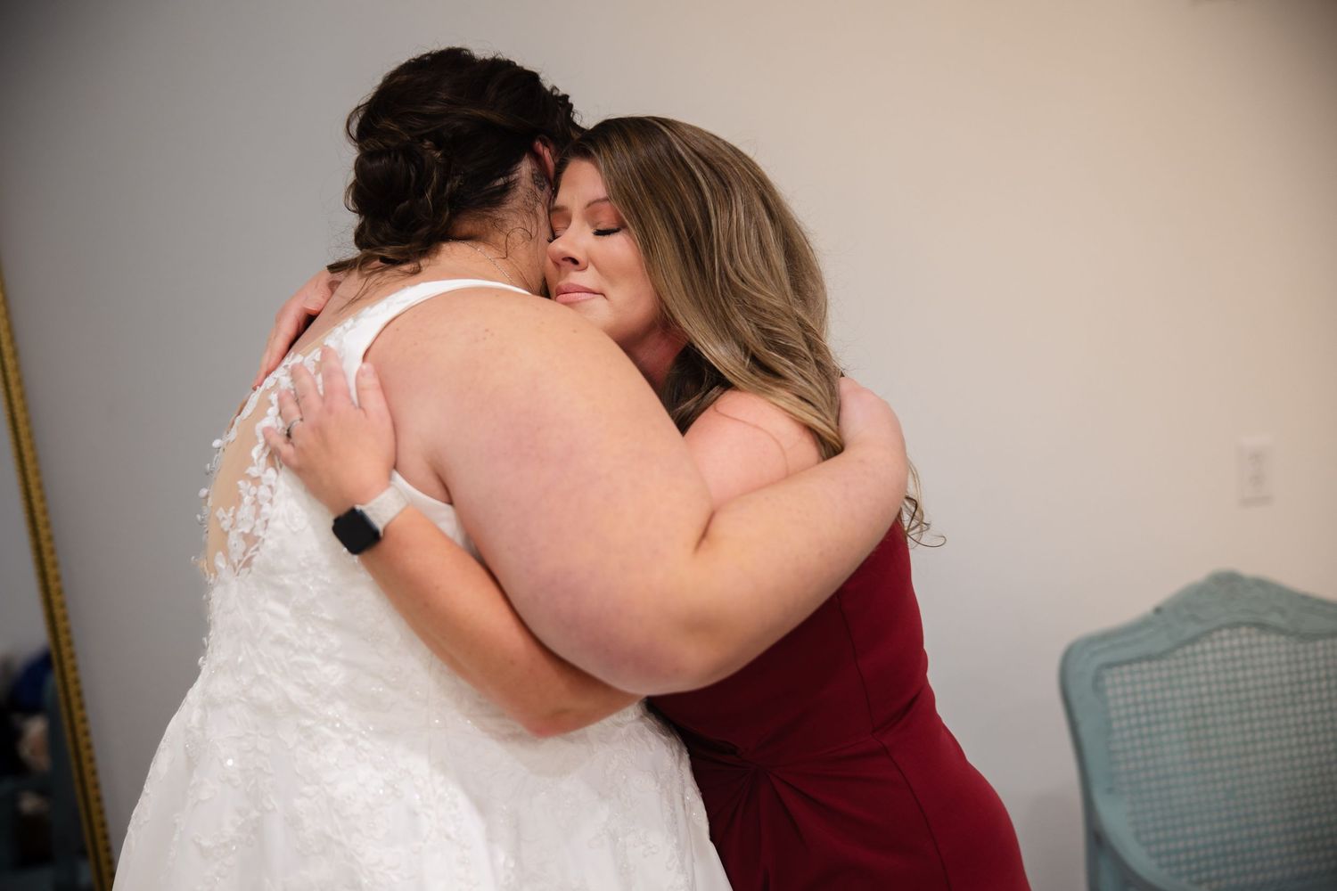 Two people share an emotional embrace in a tender moment during a special occasion.