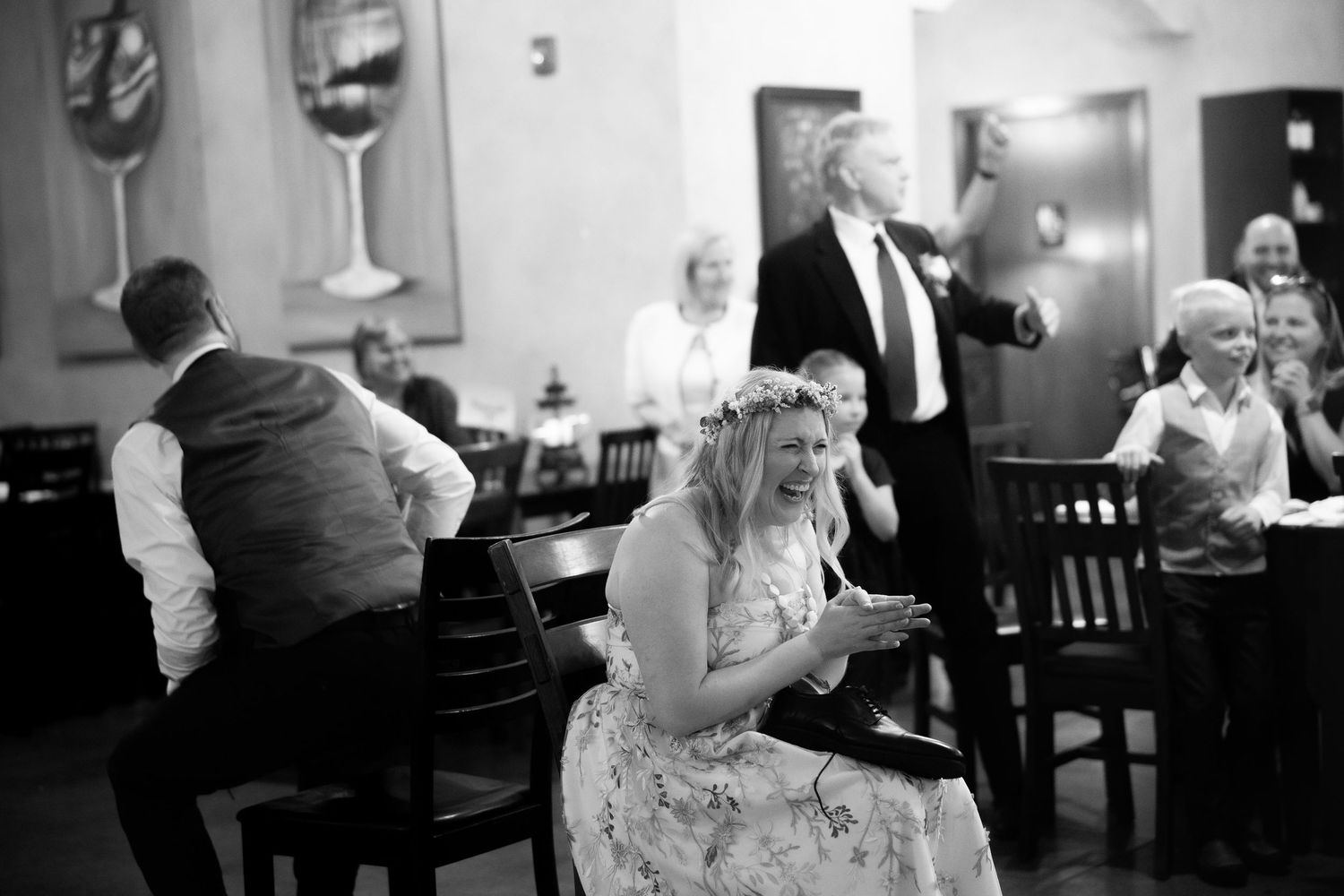 Couples dancing together at a social gathering in a dimly lit room.