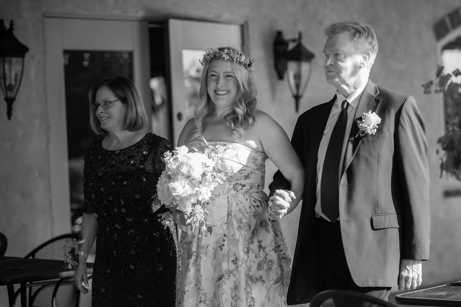 Wedding guests enjoy an elegant evening reception with decorative lighting and formal attire.