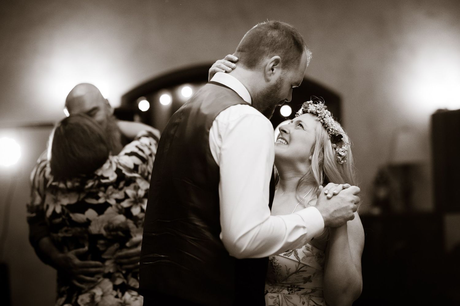 A black and white capture of a couple sharing an intimate dance moment at their wedding reception.