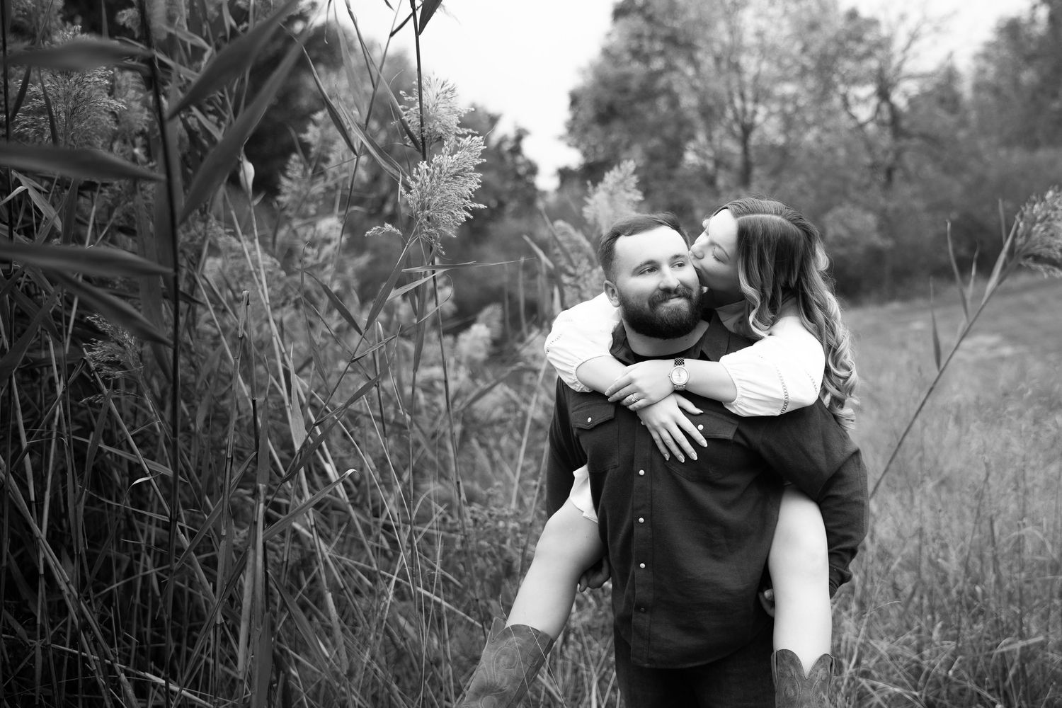 A romantic black and white photo series showing tender embraces between a couple in an outdoor setting.