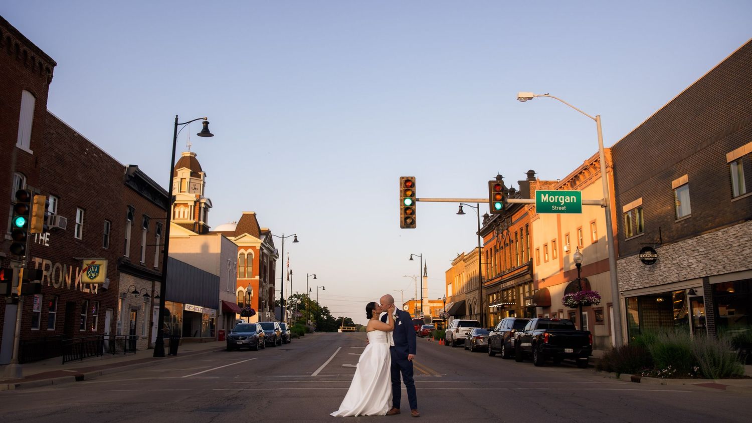 Panoramic view of a small town main street with historic buildings and a traffic light.