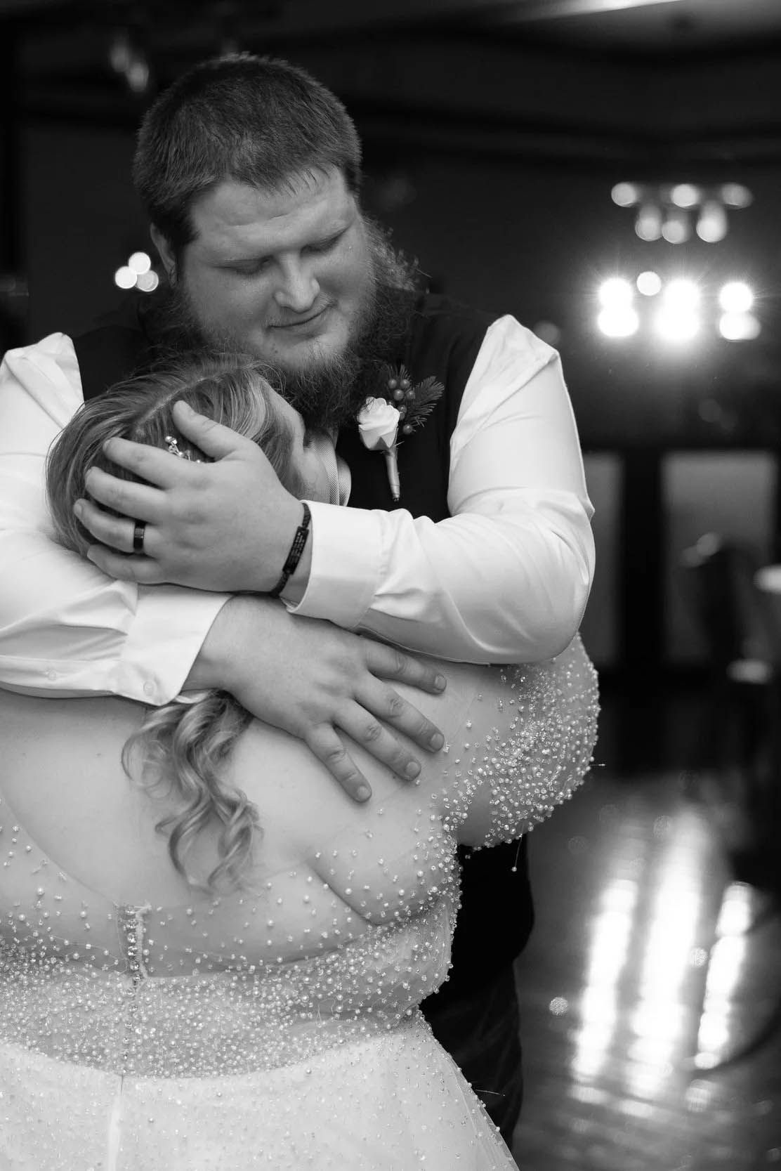 Black and white wedding dance photos showing intimate embraces in sparkling dress.