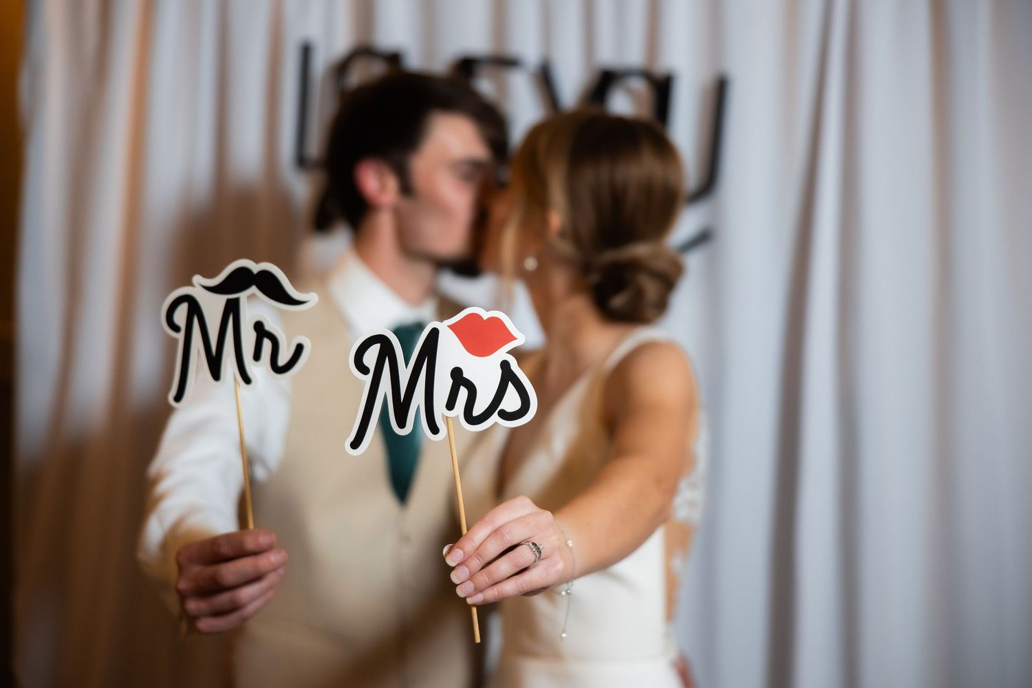 Wedding reception decor featuring Mr and Mrs signs with romantic lighting.