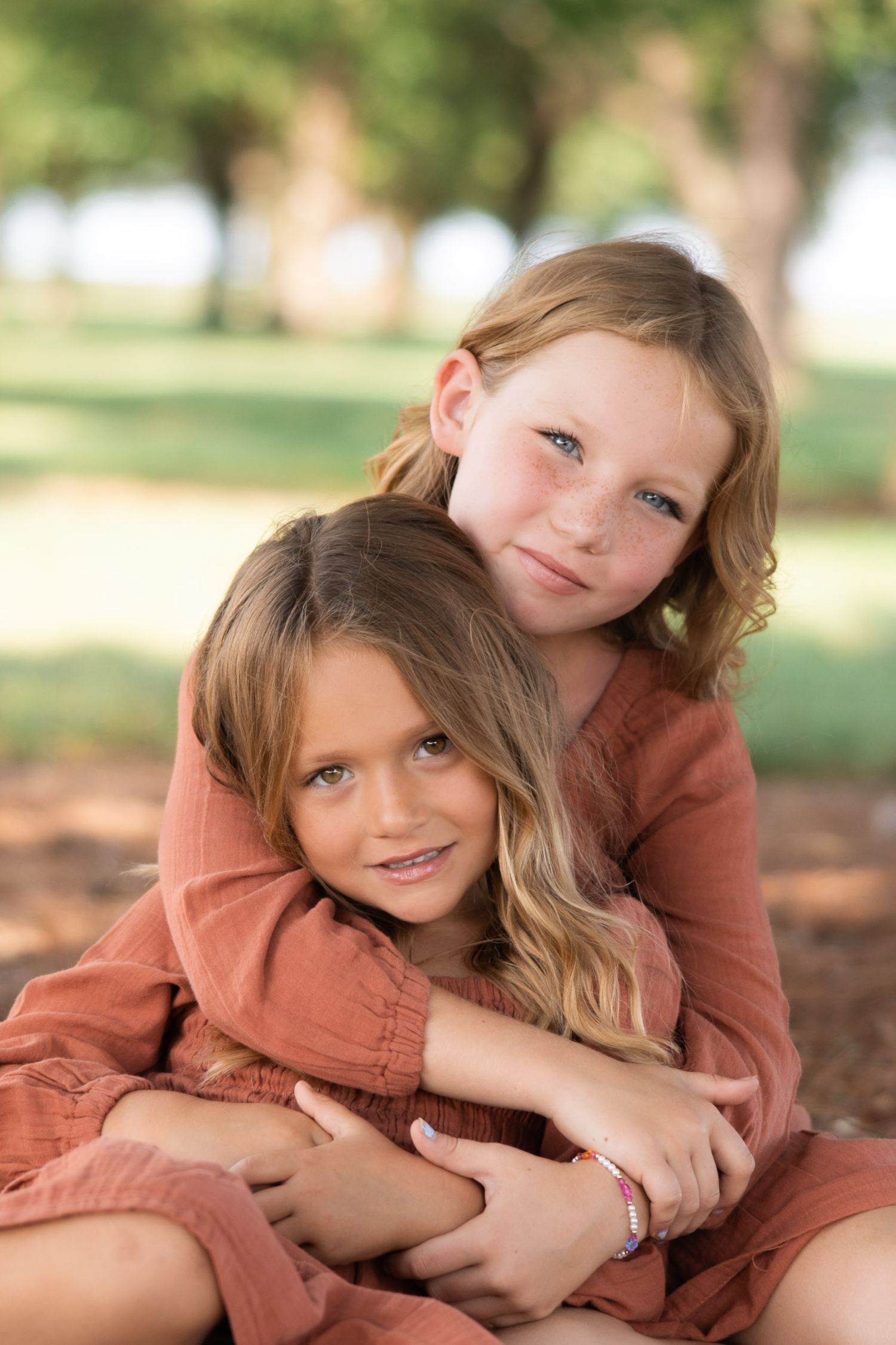 Tender embrace captured during outdoor family photo session.