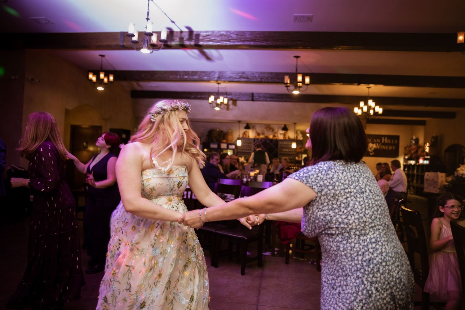 Dance floor scene with purple lighting and multiple couples dancing together.
